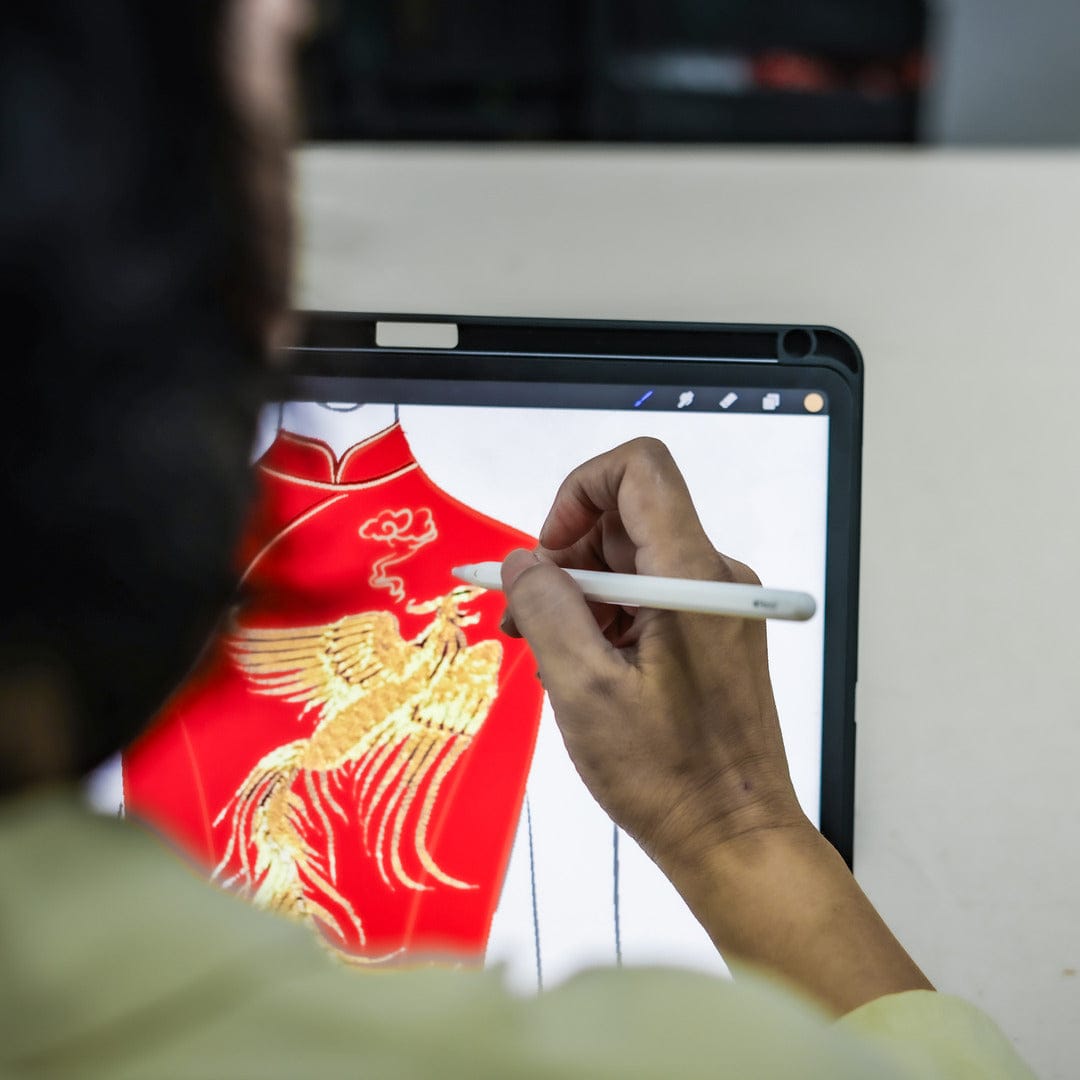Close-up image of one of our designers drawing the embroidery digital sketch.