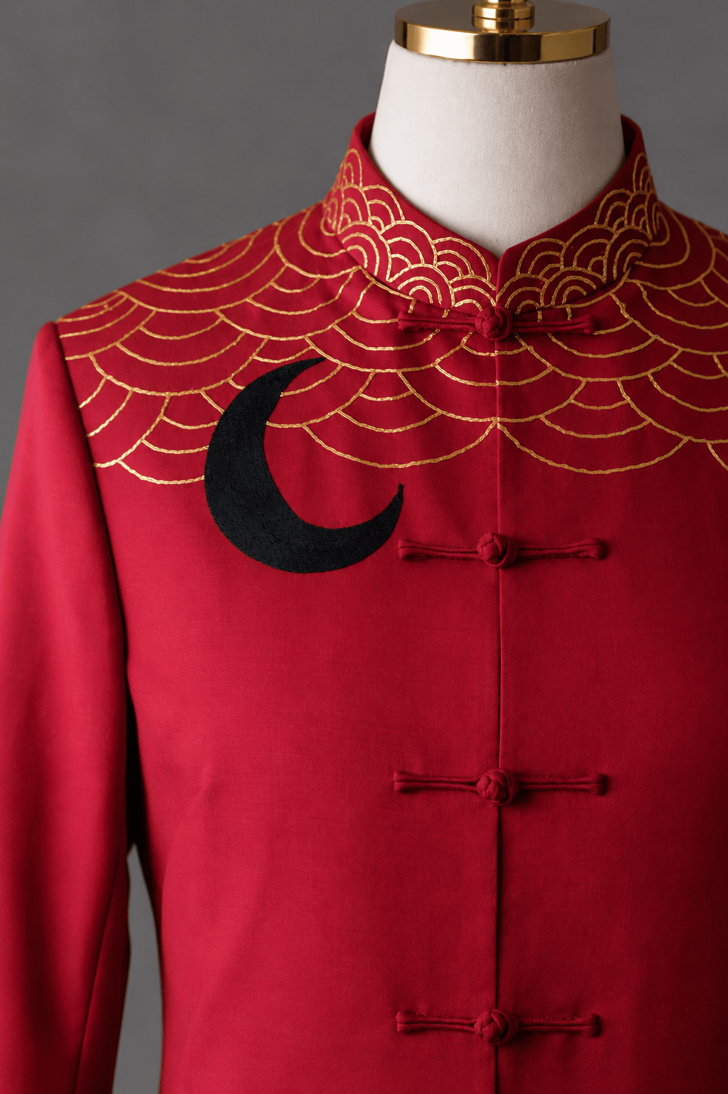 Close up of gold sea wave embroidery and mandarin collar detail on bespoke red silk Tang suit, custom made at JINZA Los Angeles
