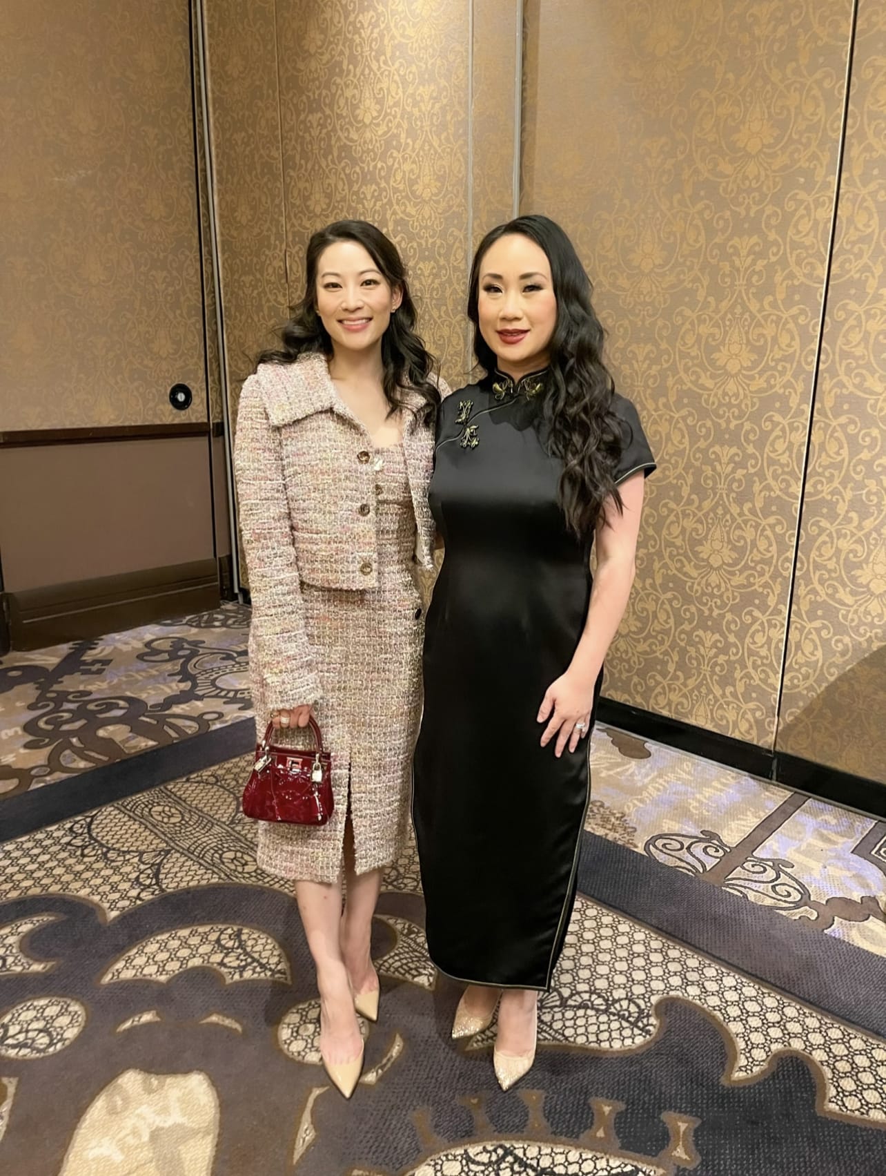 Celine wearing a black silk Qipao dress by JINZA Oriental Couture attending the Association of Corporate Counsel event with actress Arden Cho