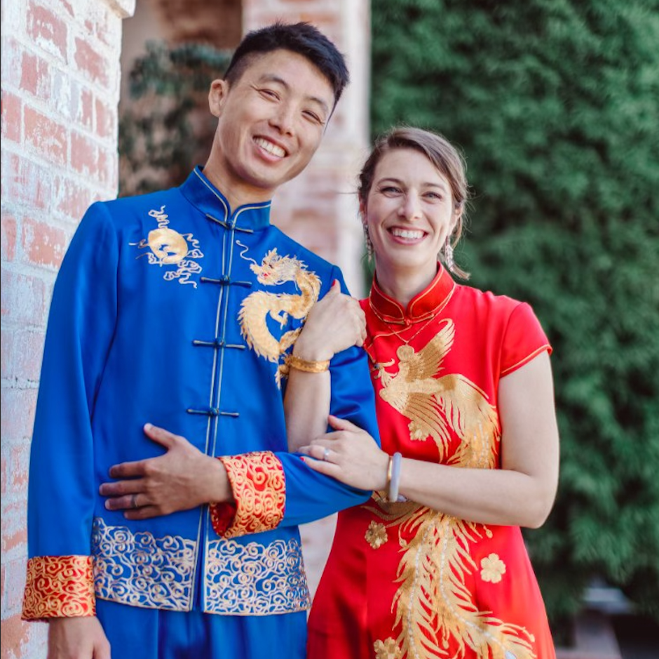 Close-up of blue silk Tang suit with anjin dragon and sun embroider.