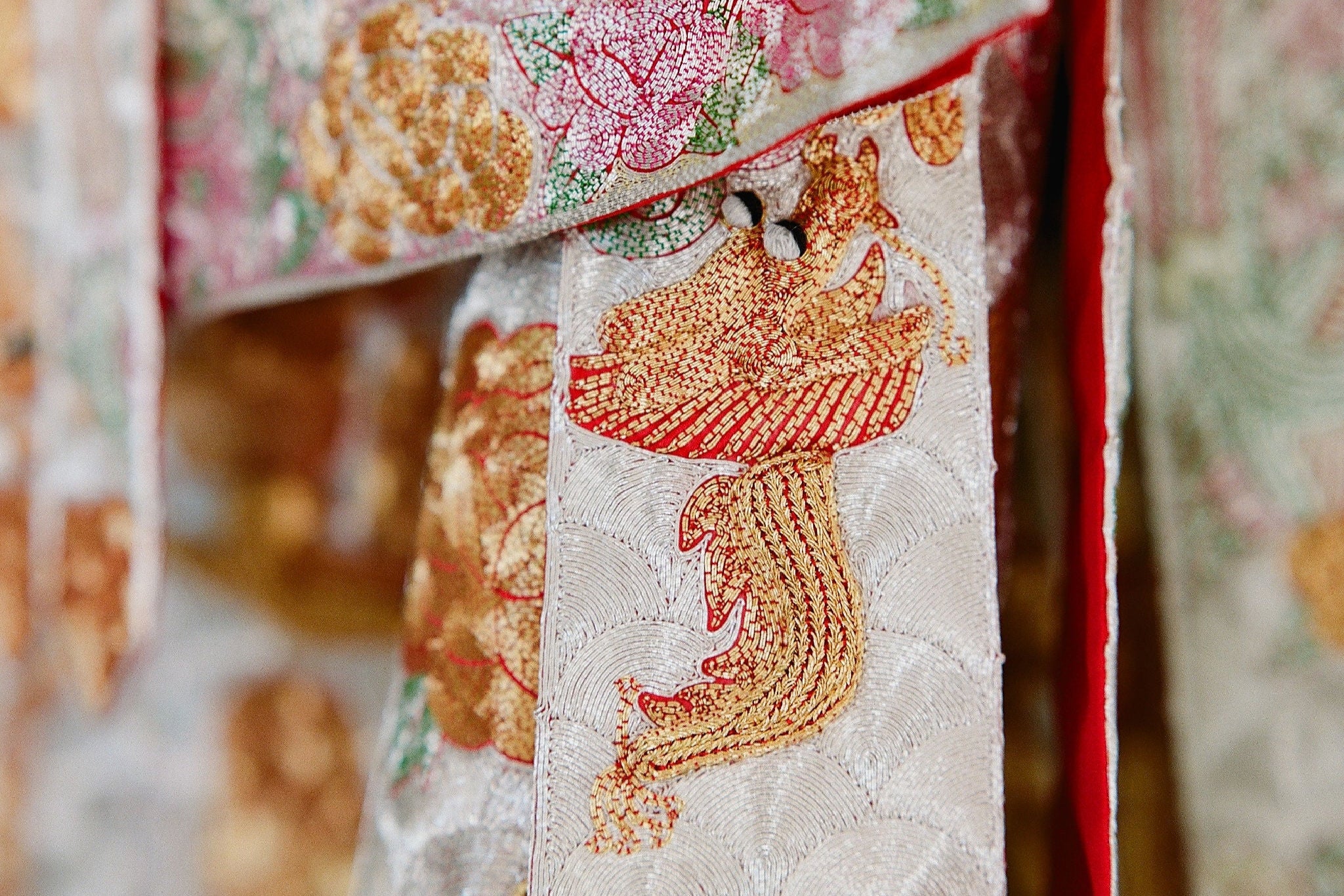 Close-up of hand embroidery on King Kwa Chinese wedding dress with gold and silver thread, symbolizing heirloom craftsmanship and cultural legacy