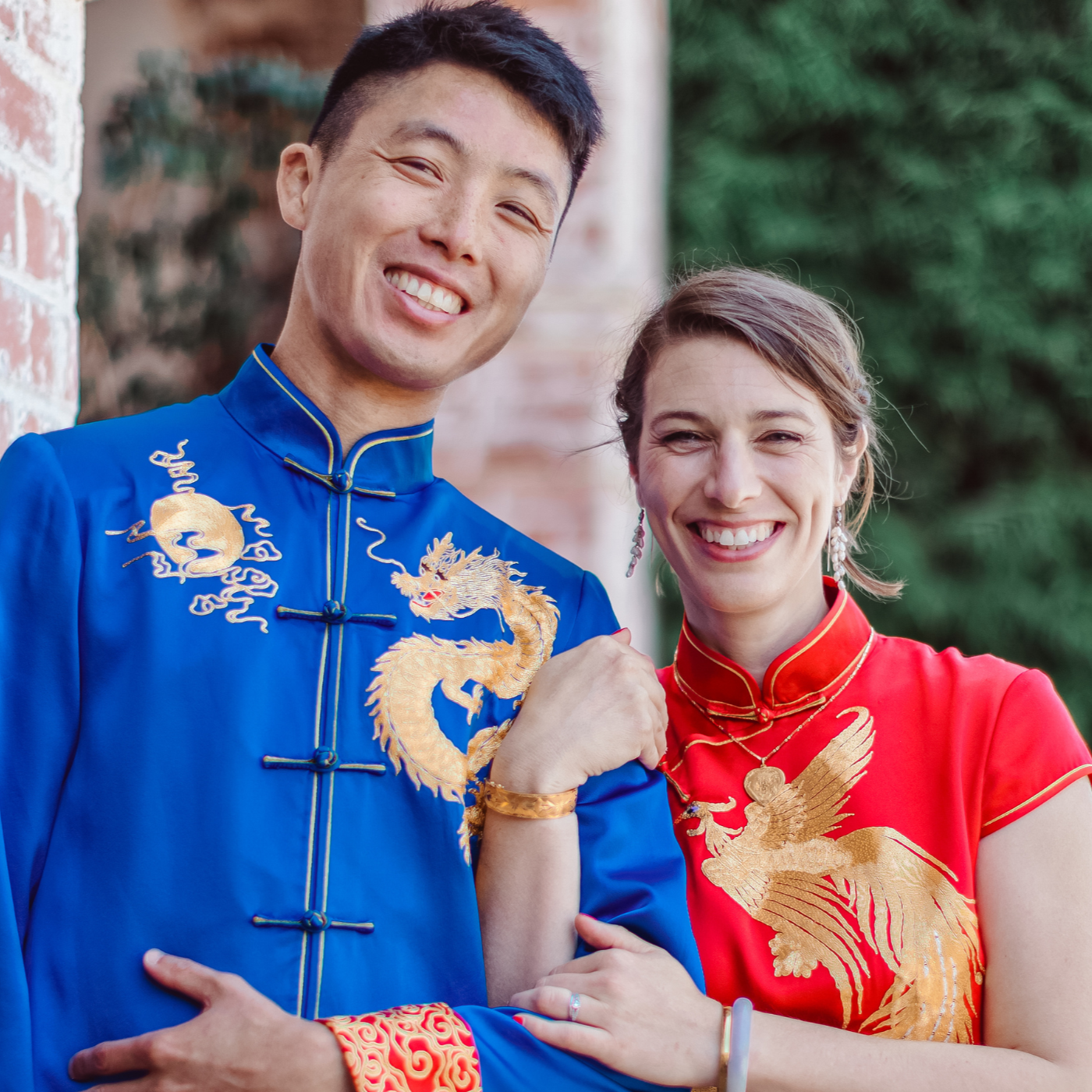 Hand-guided Chinese tea ceremony with red Qipao and blue Tang suit honoring wedding traditions