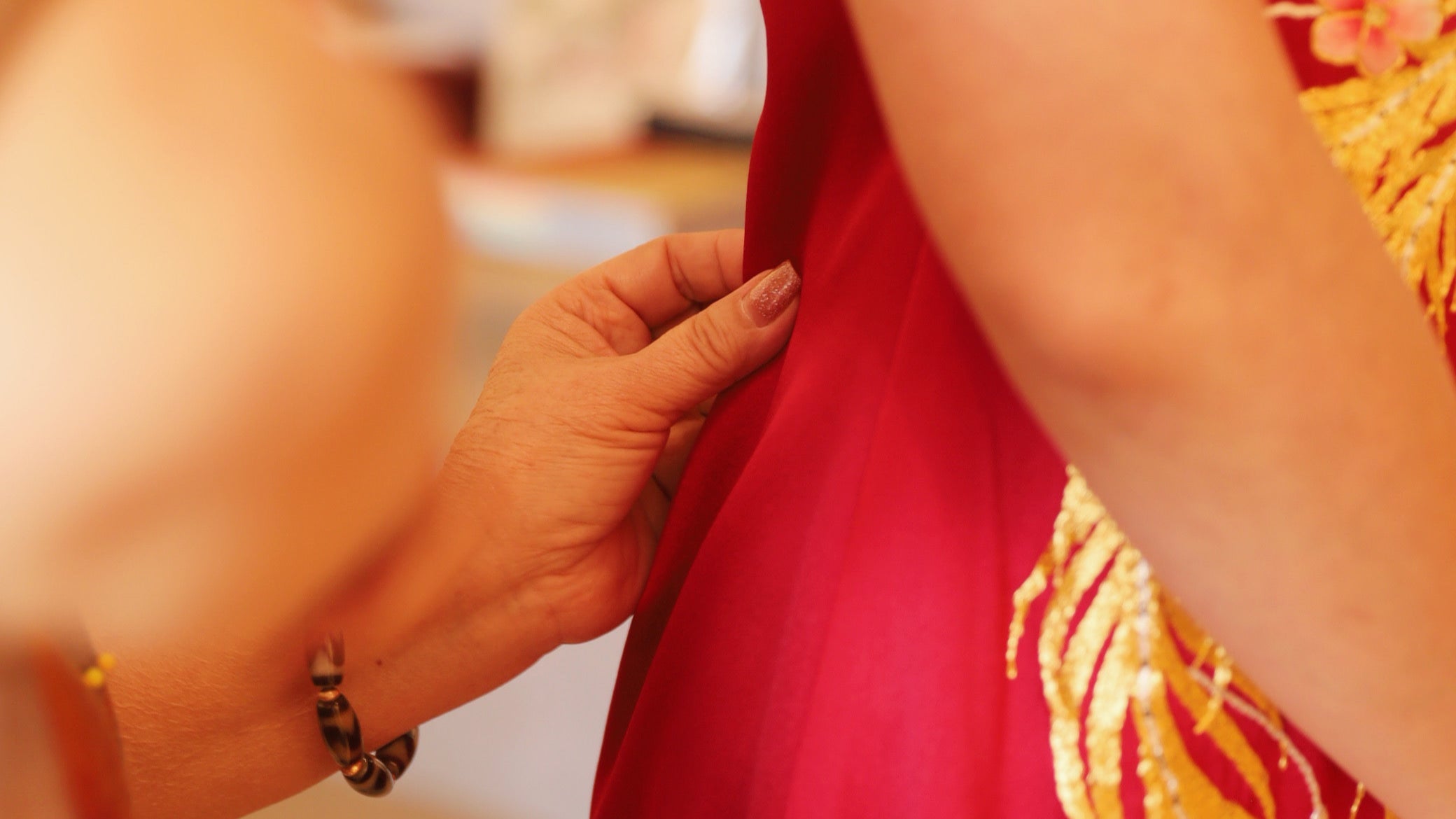 Client working with JINZA designer to personalize Qipao embroidery