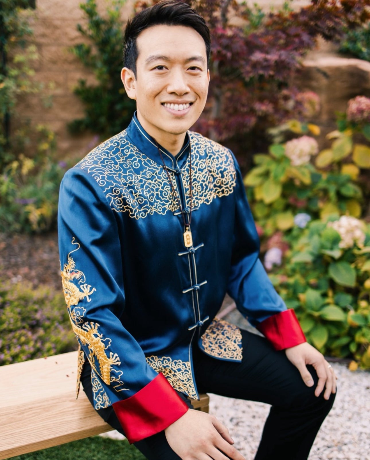 Real groom Kevin wearing blue silk tang suit at Chinese wedding