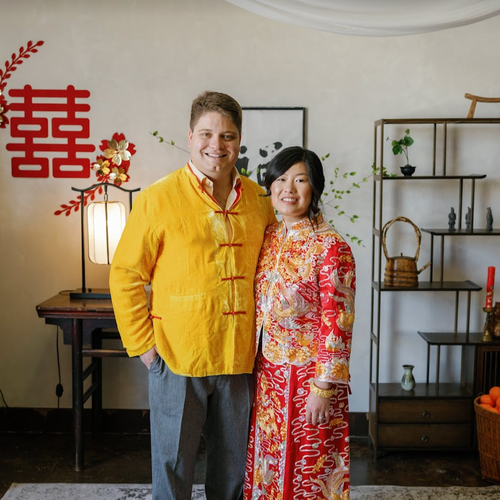 Cynthia and Jason wearing red Chinese Qun Kwa and Tang suit during their multicultural tea ceremony