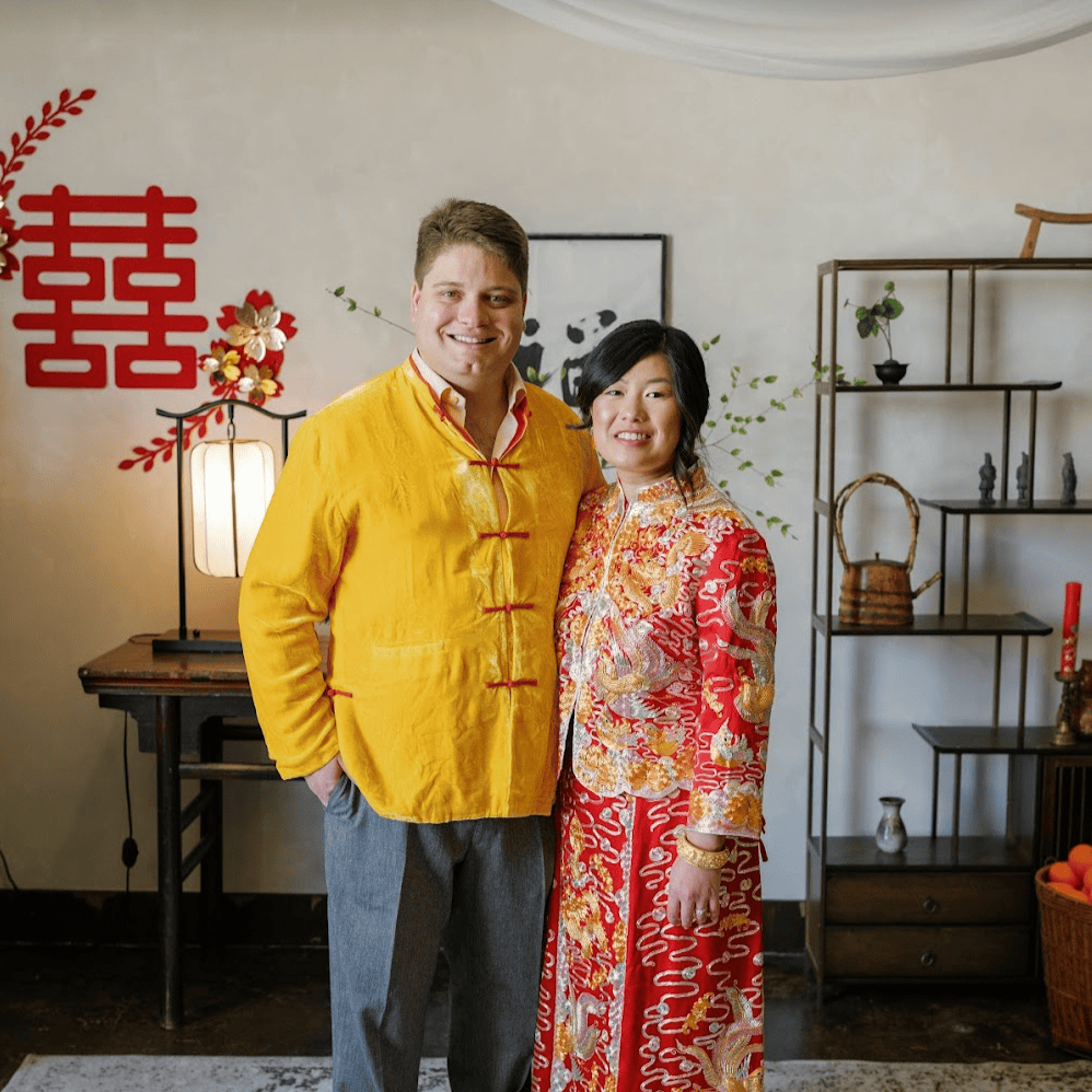 Cynthia and Jason wearing red Chinese Qun Kwa and Tang suit during their multicultural tea ceremony