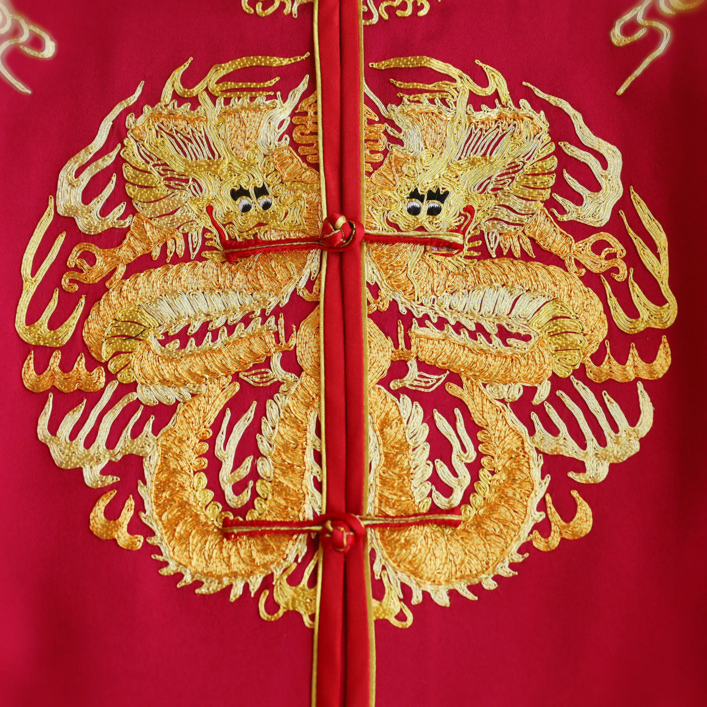 Gold embroidered dragon symbolizing power on a groom’s Chinese Tang suit