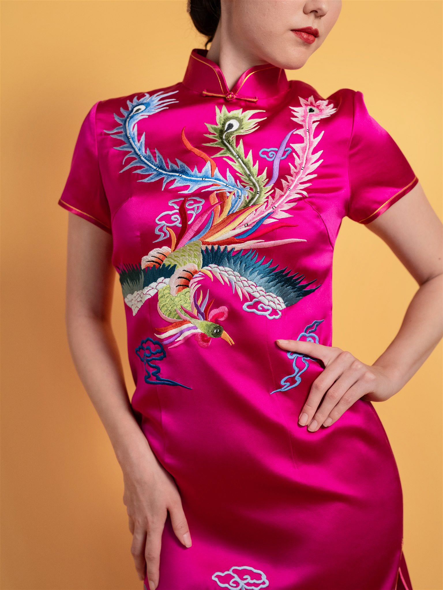 Shu embroidery detail of phoenix on fuchsia pink silk Qipao Chinese wedding dress.
