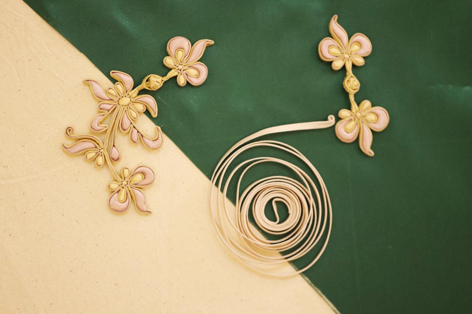 Final embroidery and hand-sewn trim on a silk Cheongsam by JINZA artisan
