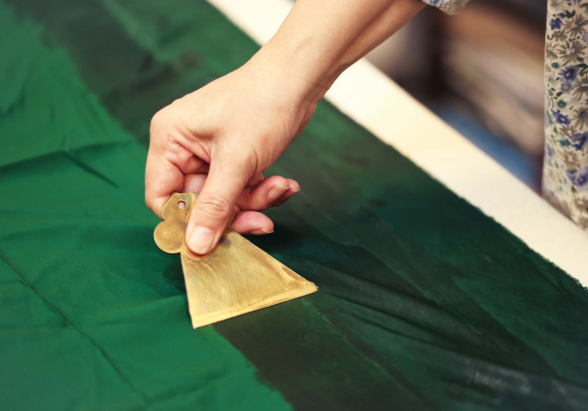 Applying traditional sizing by hand and cutting silk for a custom Qipao dress