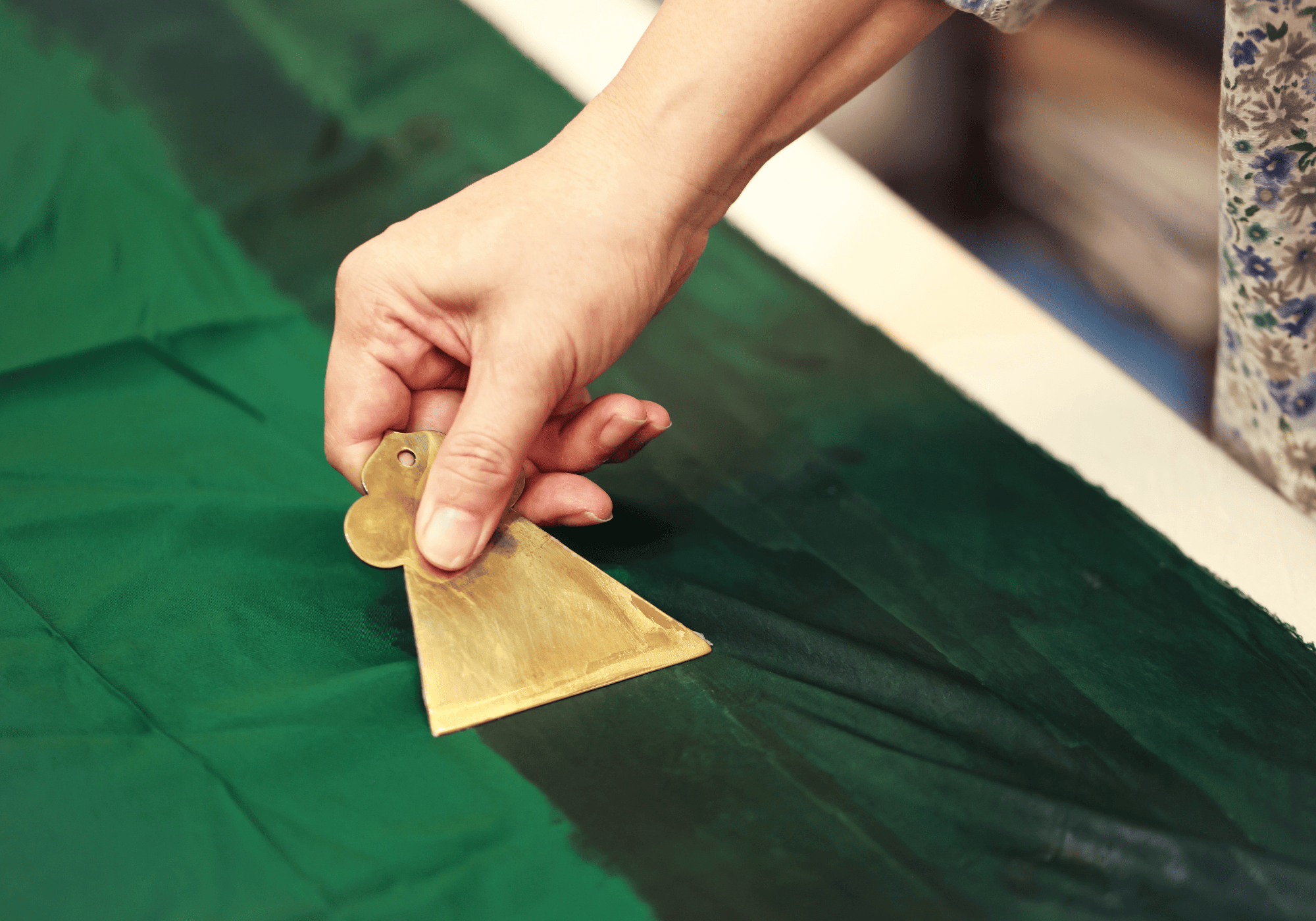 Applying traditional sizing by hand and cutting silk for a custom Qipao dress