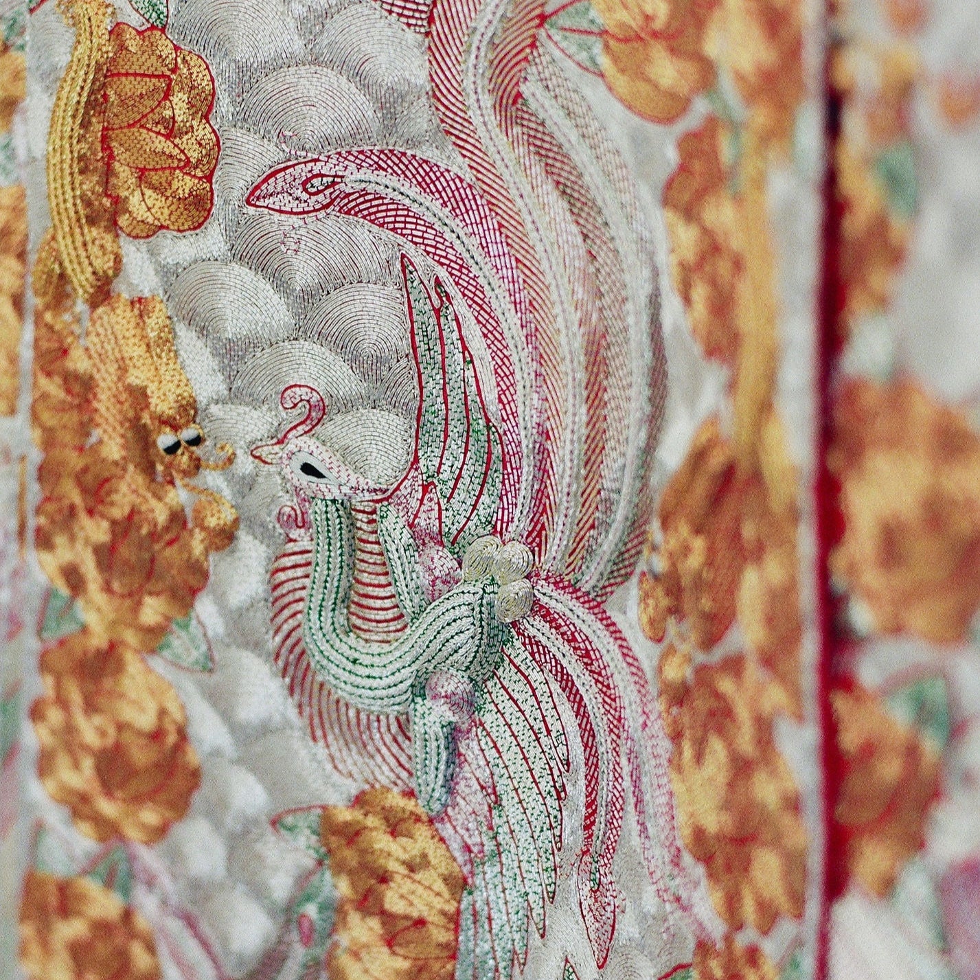 Gold phoenix and dragon embroidery on King Kwa Chinese traditional wedding dress with red silk base
