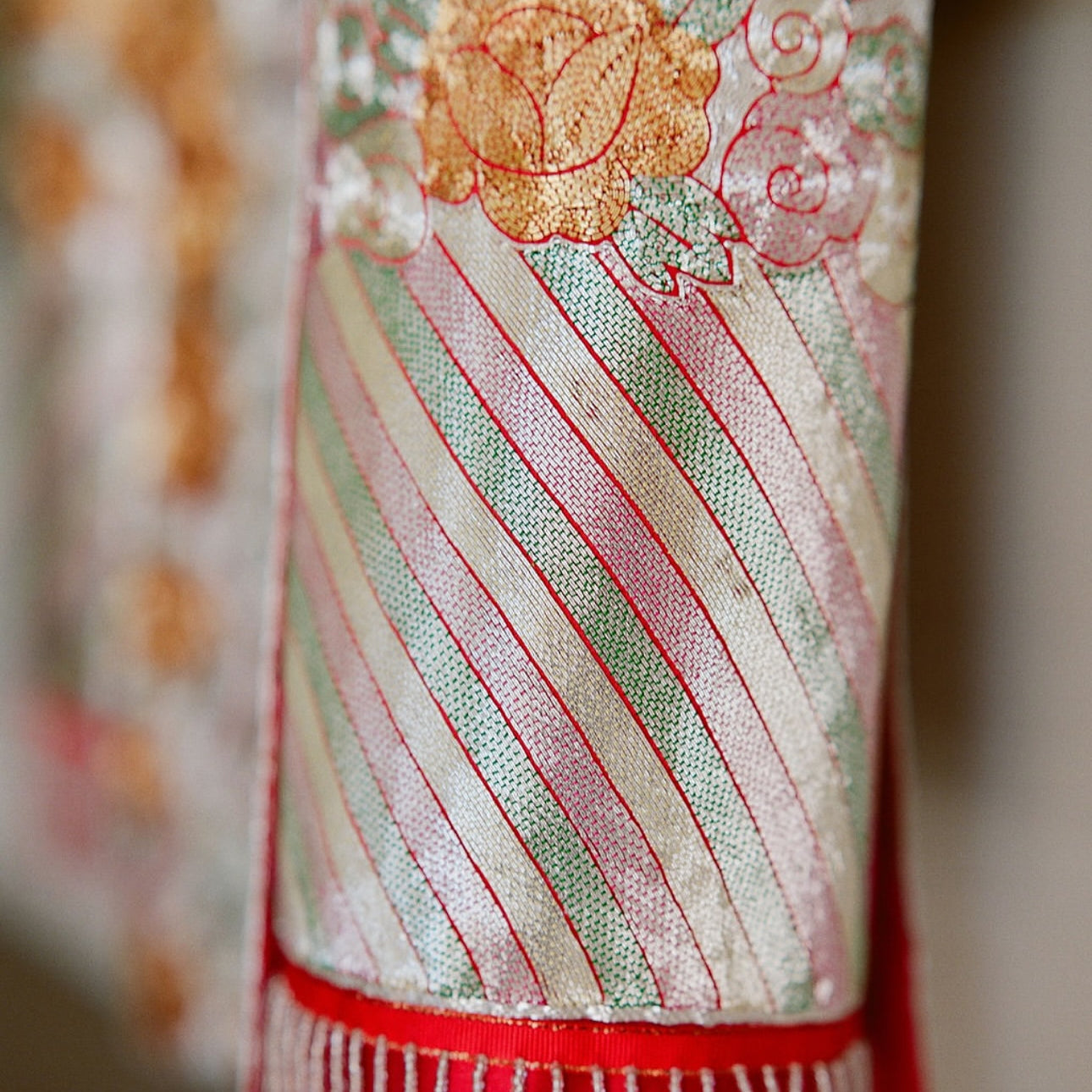 Hand-embroidered lucky clouds on neckline and trim of traditional Qun Kwa for harmony and peace