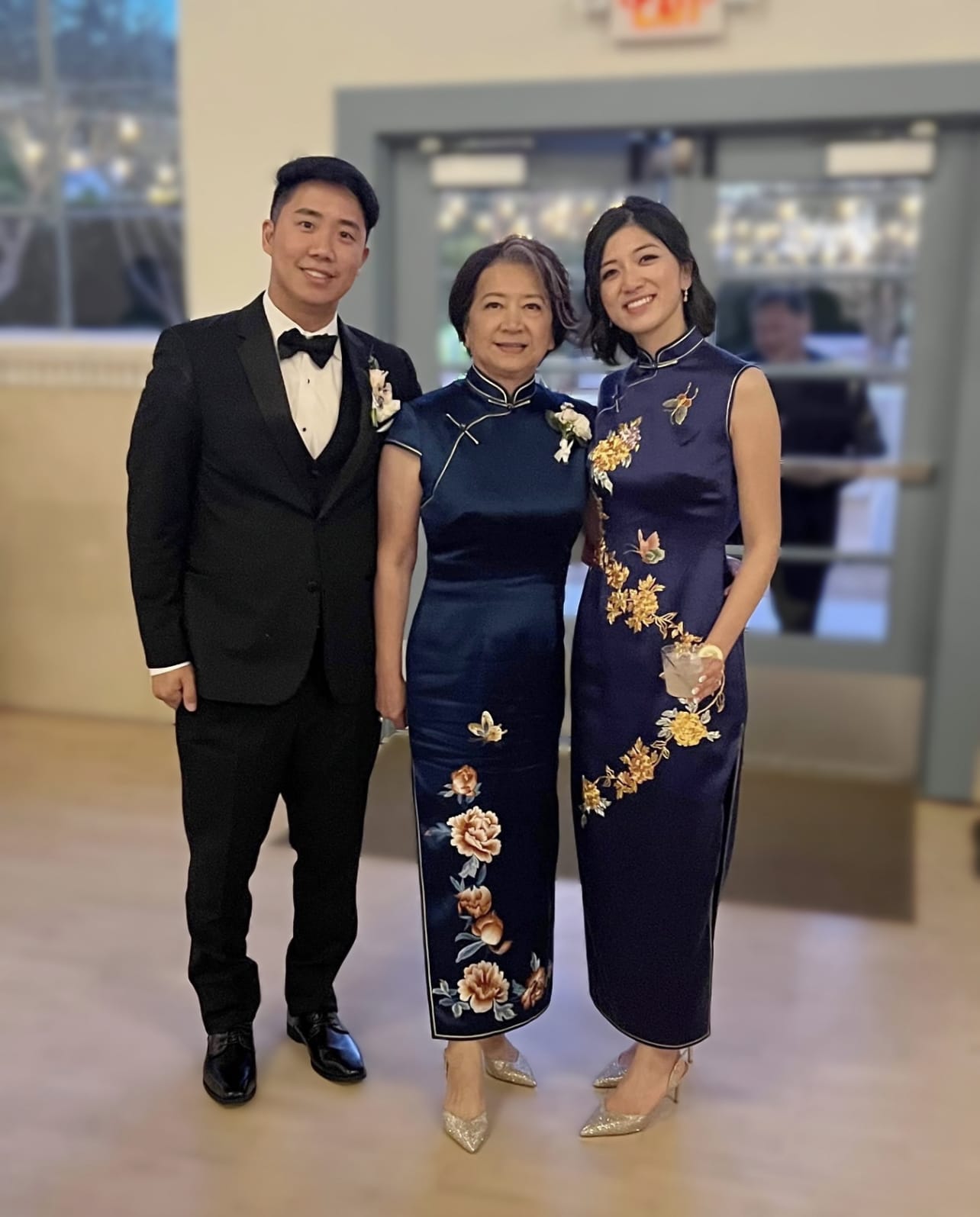 Bride and mother wearing matching navy blue Qipao with Panjin hand embroidered peonies at Chinese wedding tea ceremony, custom made to measure at JINZA Los Angeles