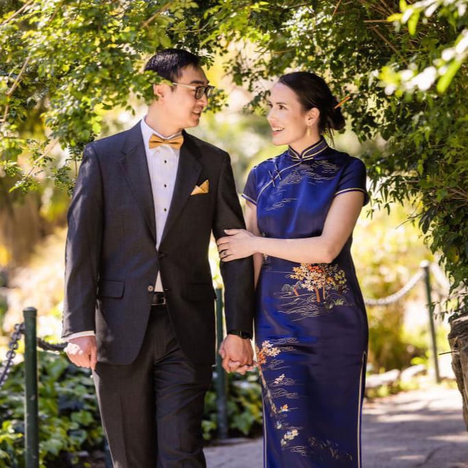 Melissa wearing the blue “Poet Over the Mountain” Qipao for her Chinese wedding ceremony, honoring her husband’s heritage.