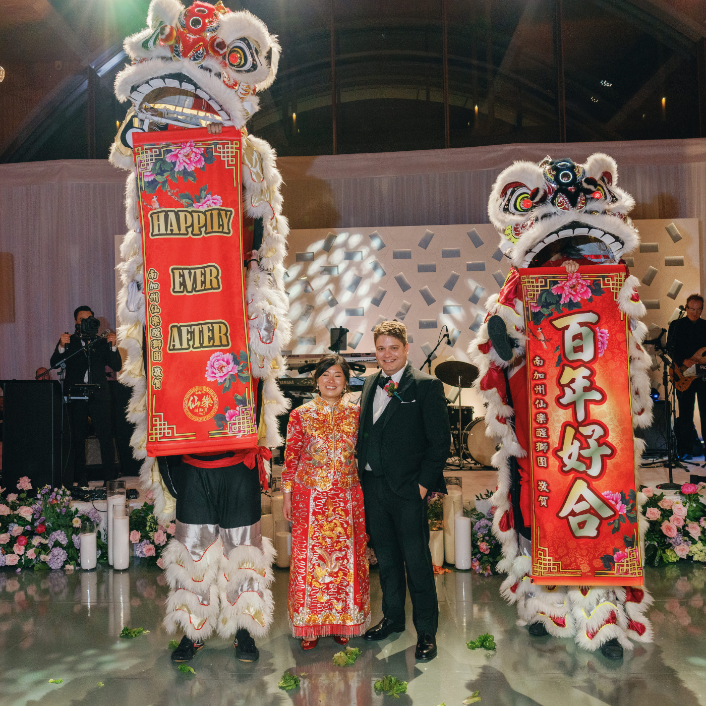 Cynthia and Jason celebrating their multicultural wedding with lion dance in traditional and Western outfits