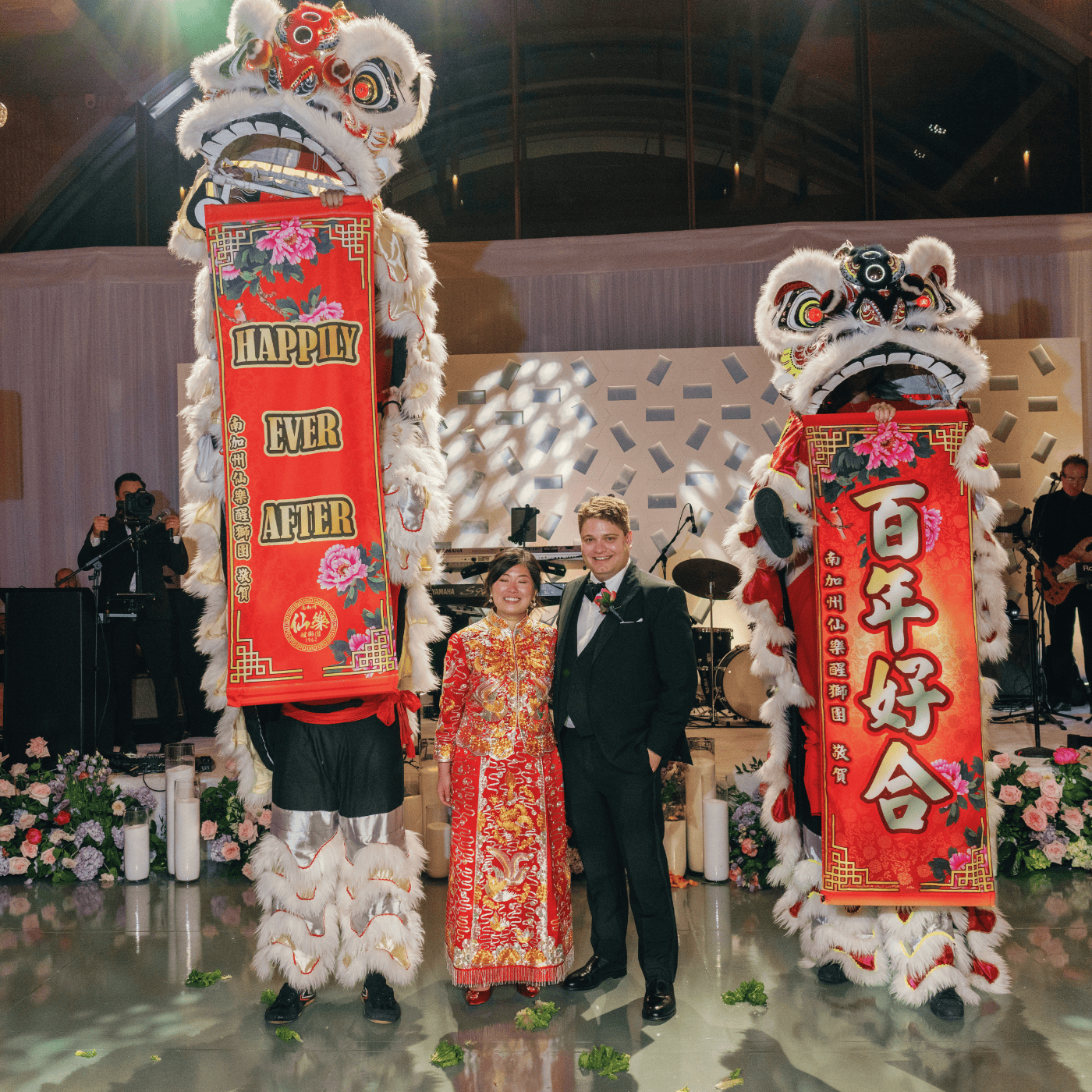 Cynthia and Jason celebrating their multicultural wedding with lion dance in traditional and Western outfits
