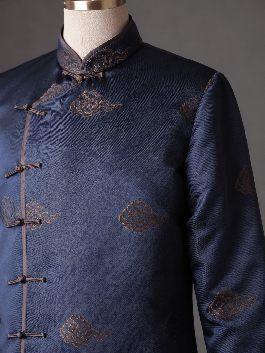 Close up of woven lucky cloud pattern on navy charcoal silk brocade Tang suit — auspicious motif detail by JINZA Oriental Couture, Los Angeles