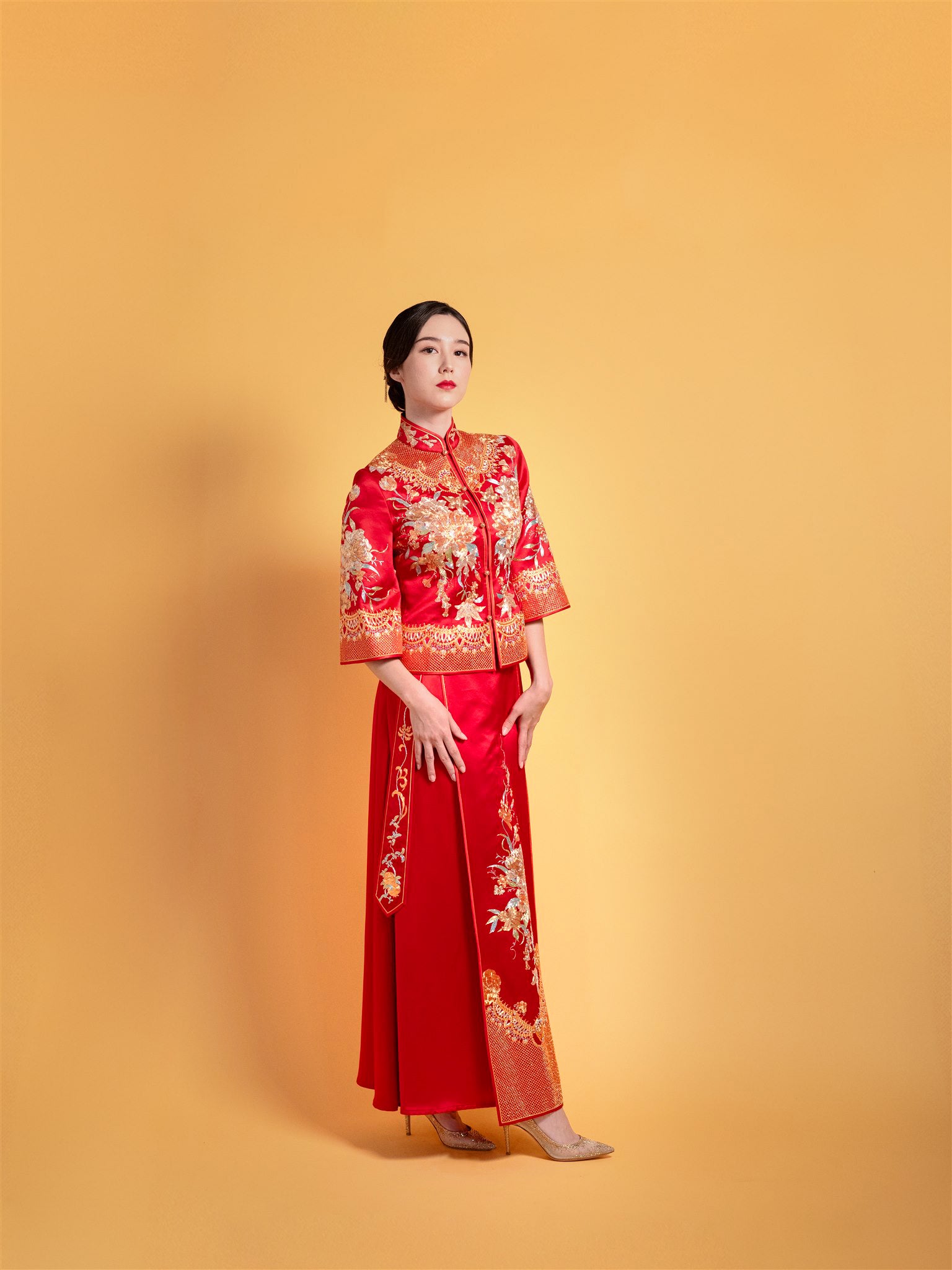 Side view of fitted jacket and paneled skirt on red Xiu He Fu