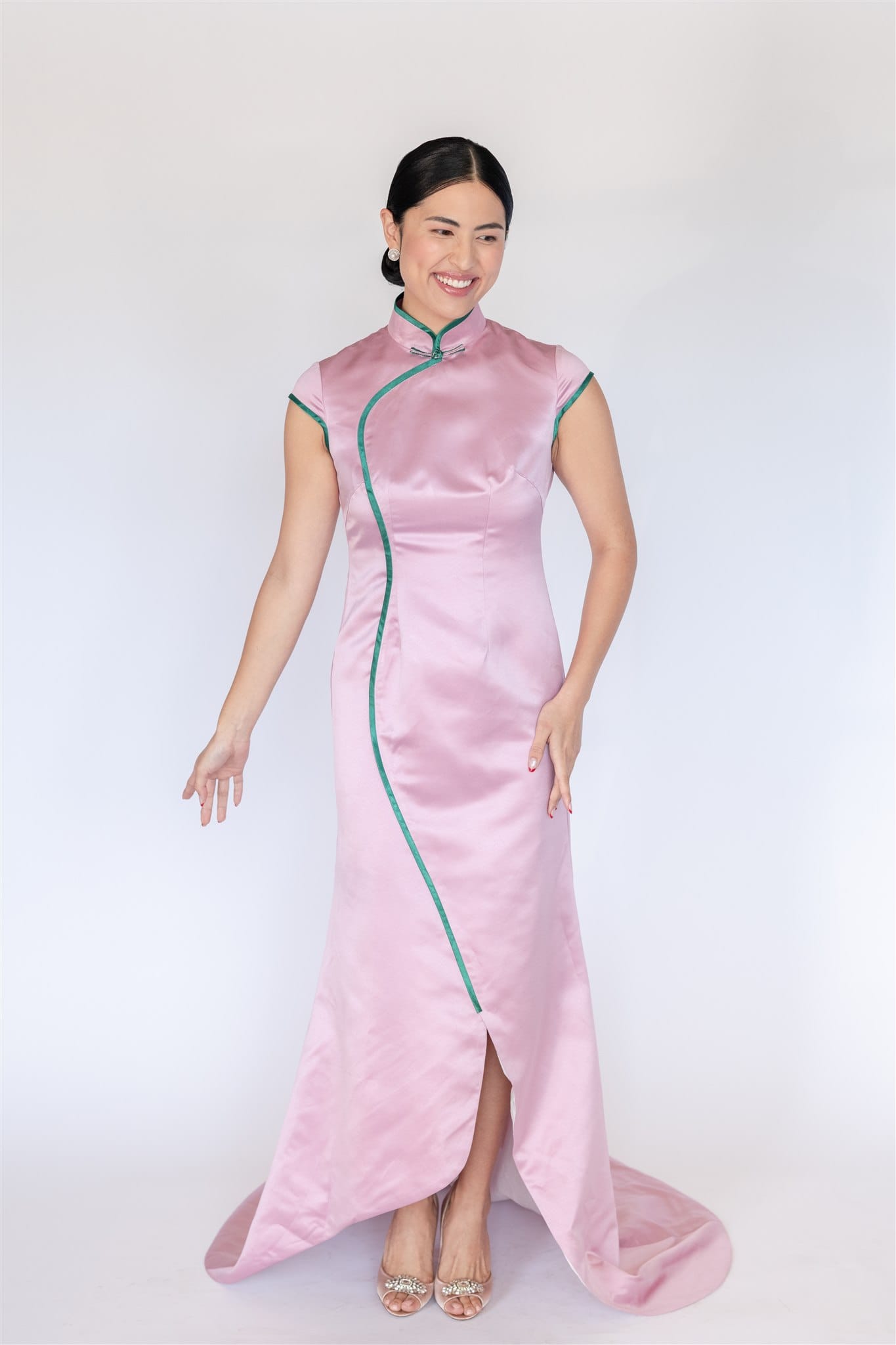 Pink silk mermaid Cheongsam with green trim and chapel train, front view.