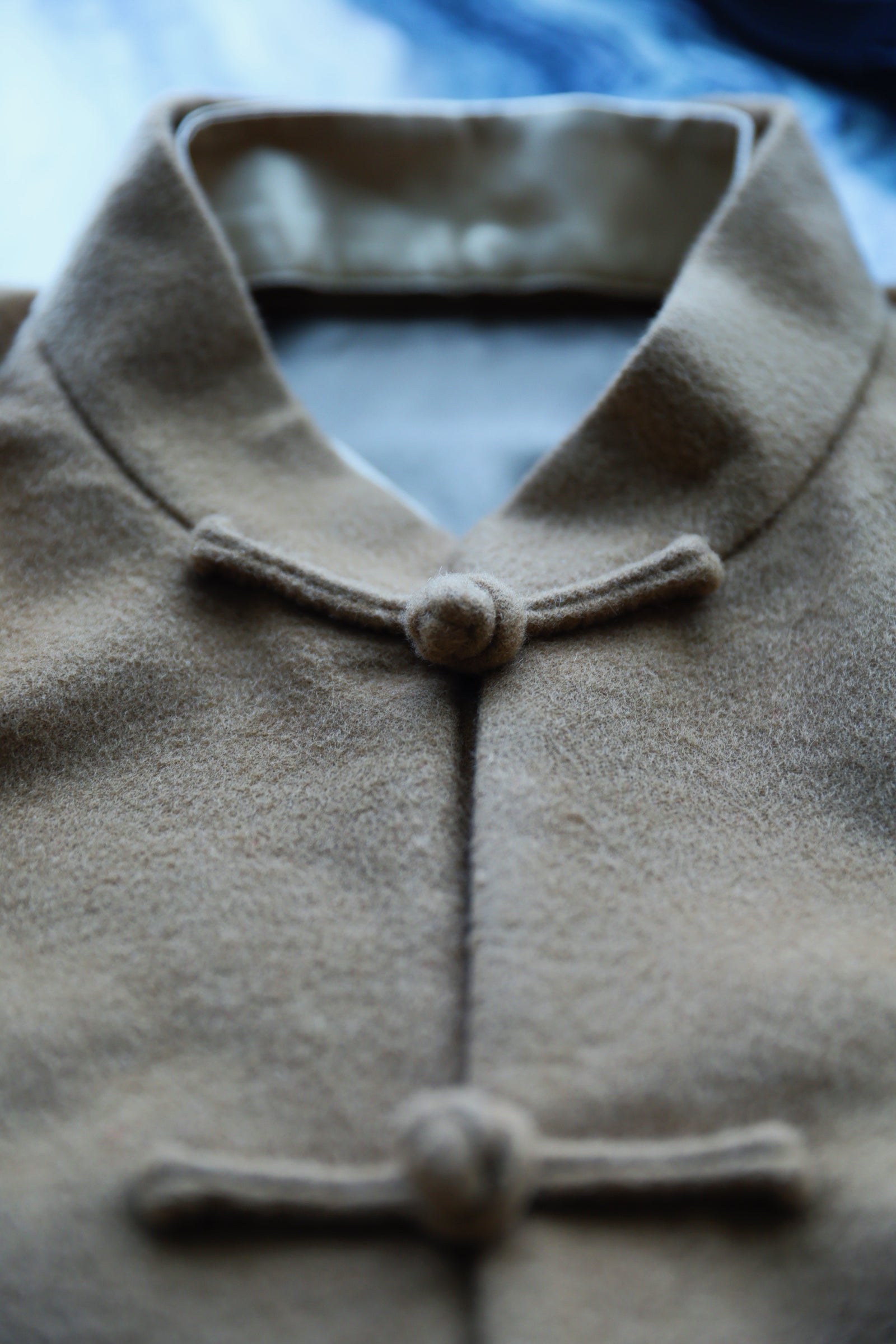 Hand-sewn frog closure detail on premium Italian wool Tang suit.