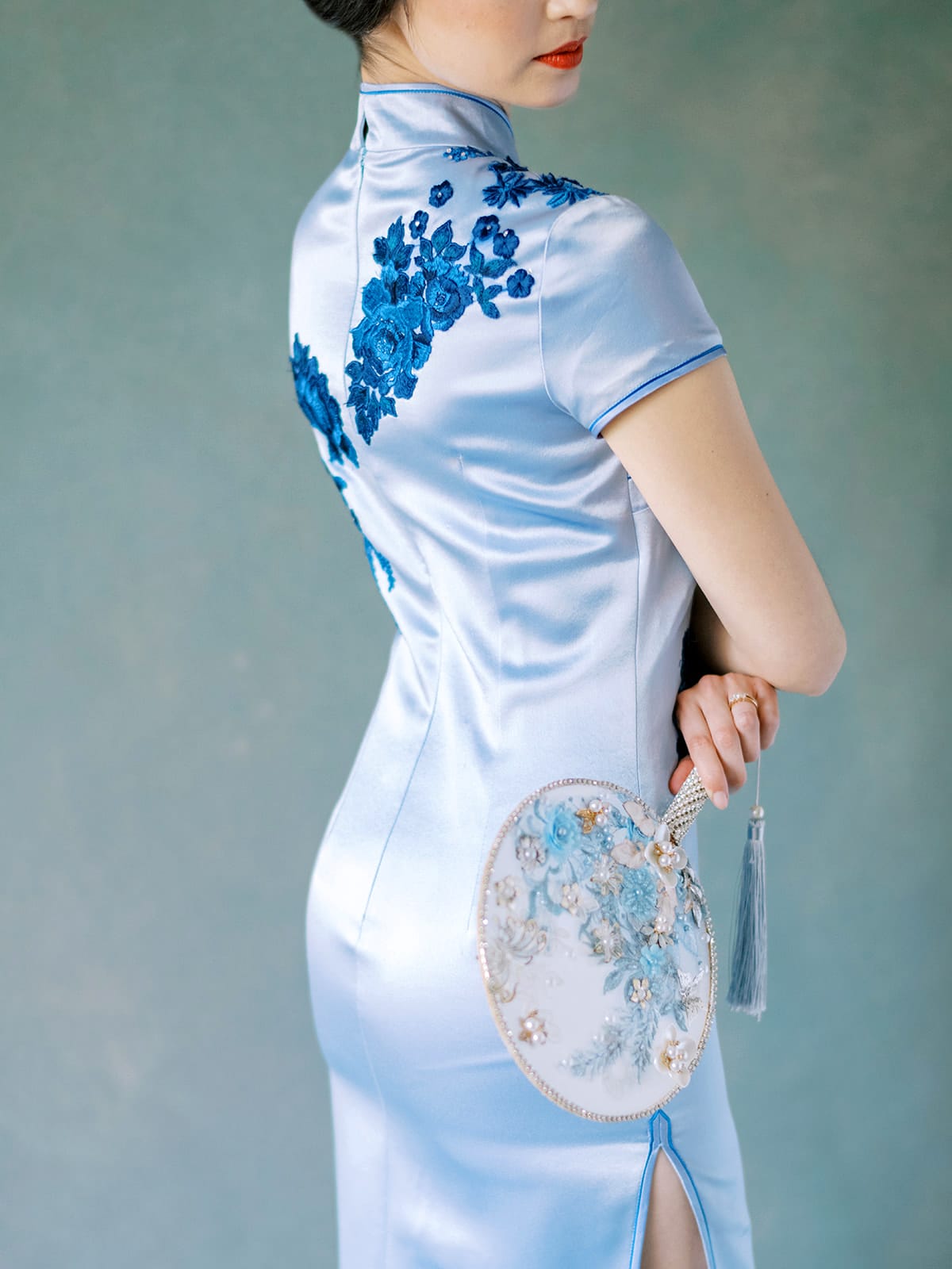 Side view of purple silk Cheongsam dress with velvet flower appliqué.