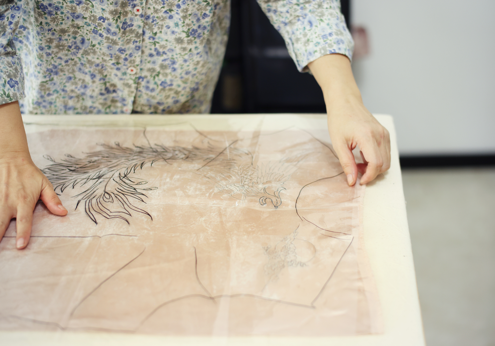 Hand sketching embroidery motif on silk for custom Cheongsam