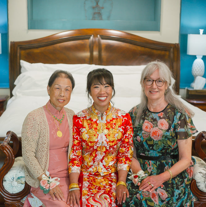 Loretta in custom red Qun Kwa with her mother and mother in law