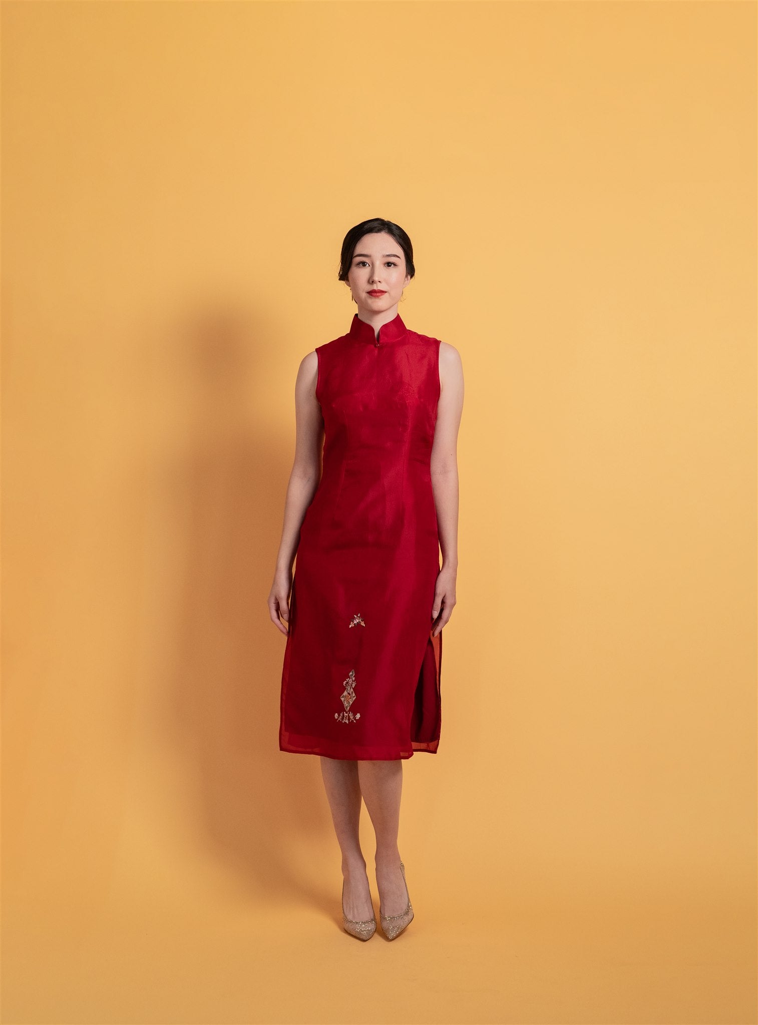 Front view of red silk organza Qipao Chinese wedding dress with sleeveless A-line cut.