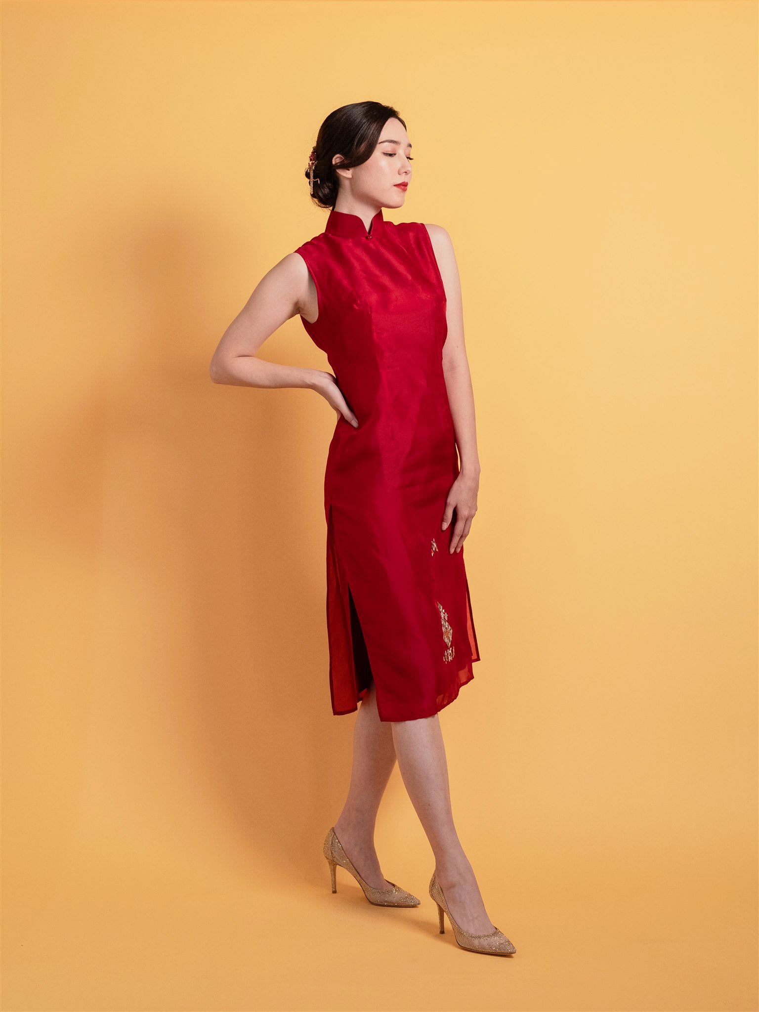 Side view of red silk organza Qipao Chinese wedding dress showing knee-length A-line silhouette.