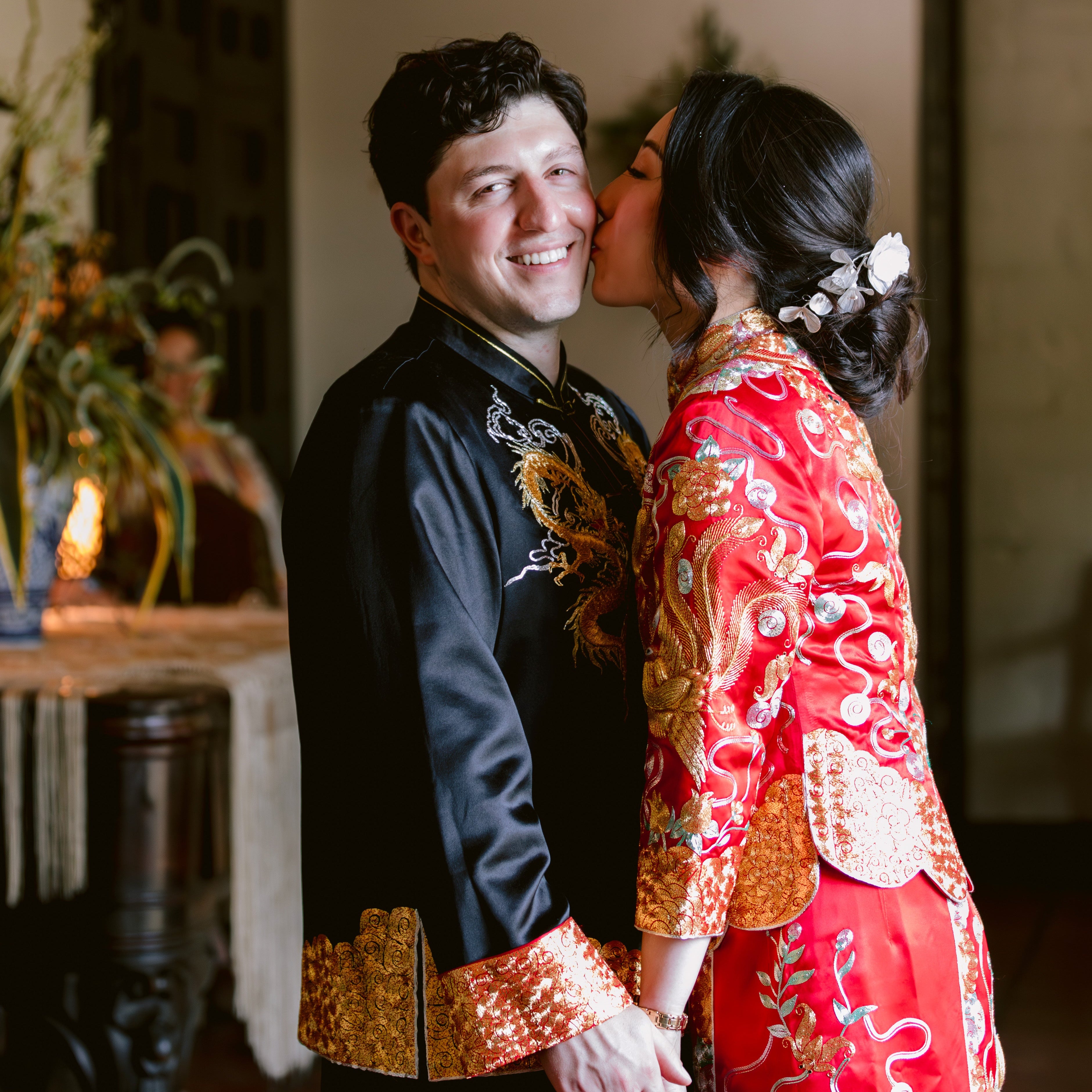 Real couple wearing custom Tang suit with skirt and Qun Kwa, a matching outfit by JINZA for a multicultural wedding.