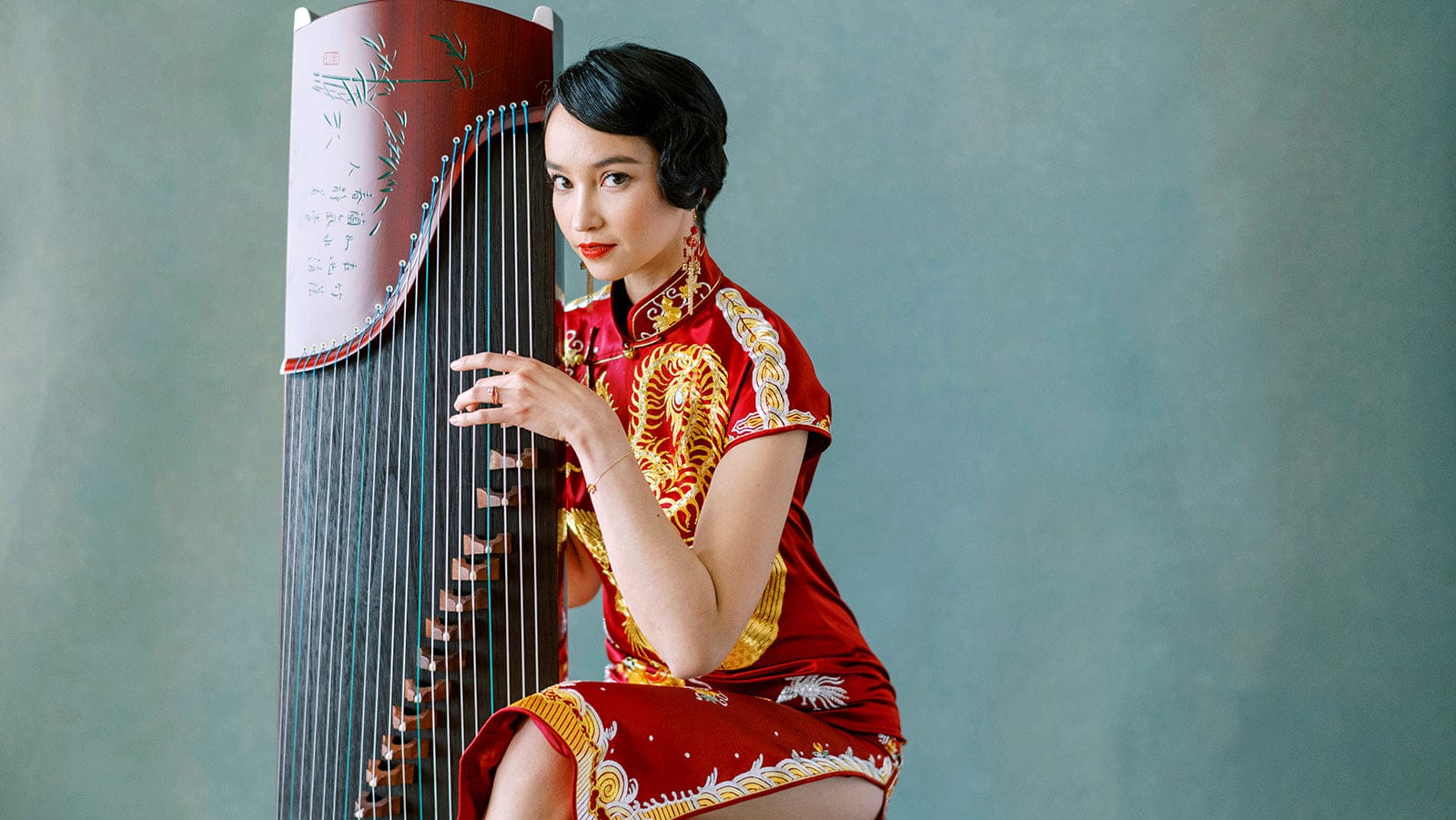 Traditional Qipao dress in green silk with vintage Shanghai background