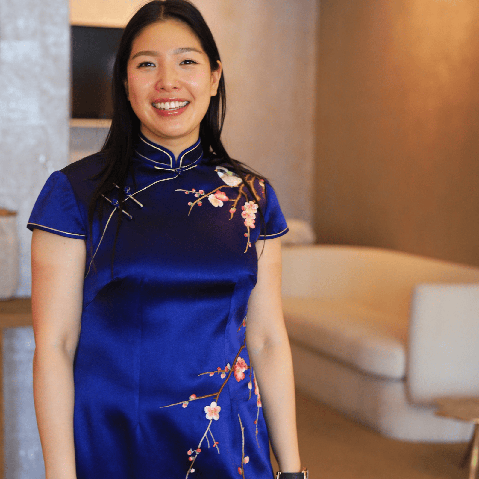 Real client wearing traditional navy blue silk Qipao with hand embroidered cherry blossom and bird motifs, custom made to measure at JINZA Los Angeles