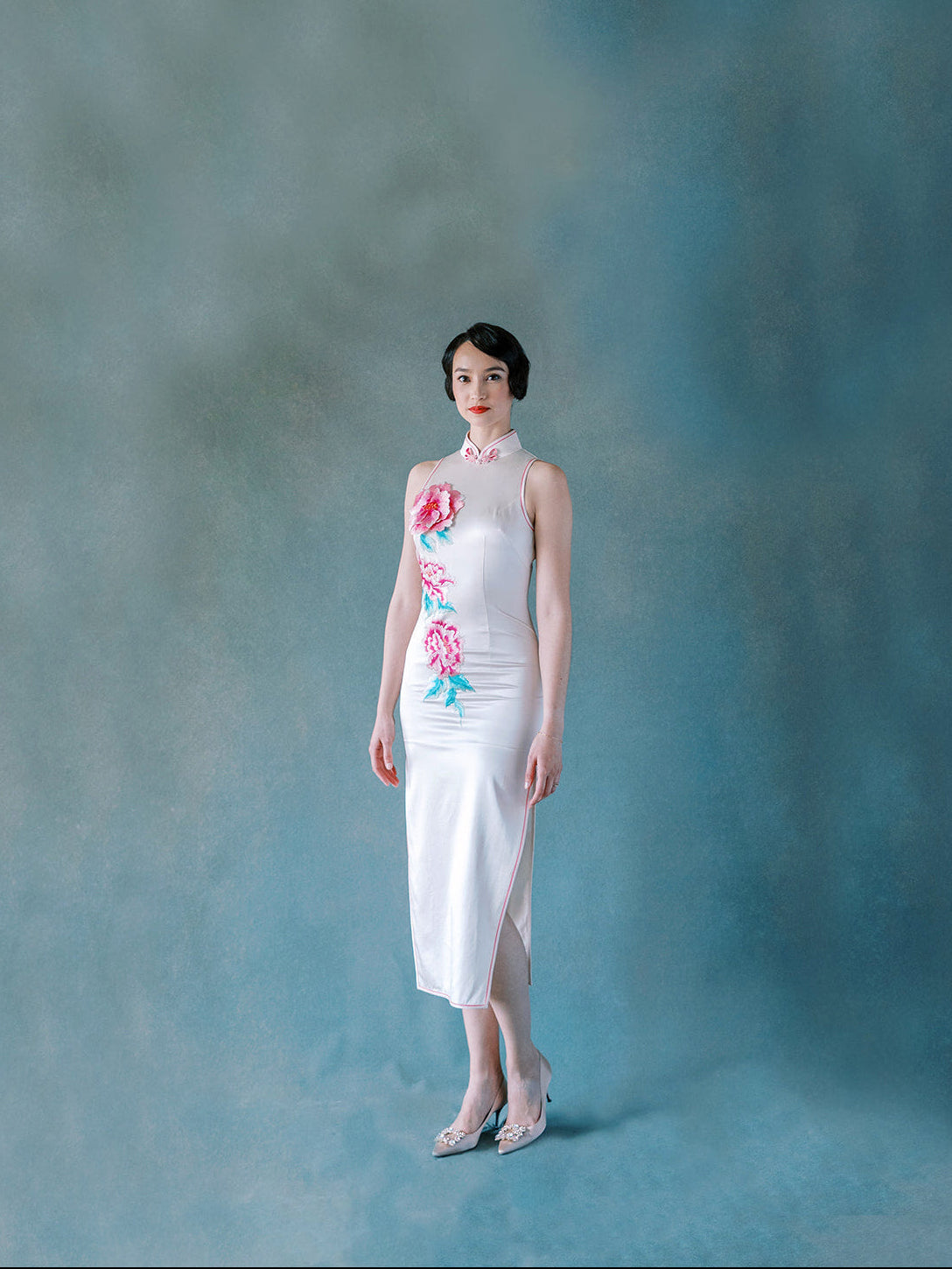 Front view of white silk halter Qipao dress with 3D embroidered peony motif.