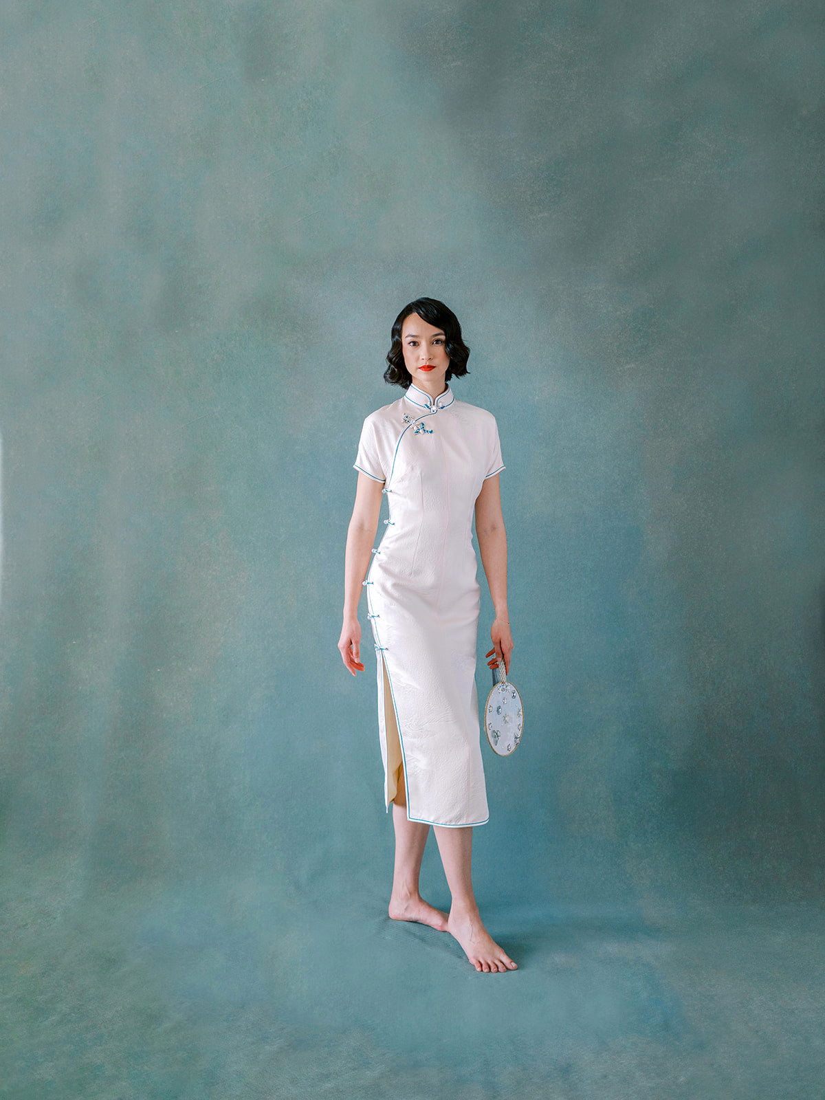 White silk Qipao with blue trim and side Pankou button closure