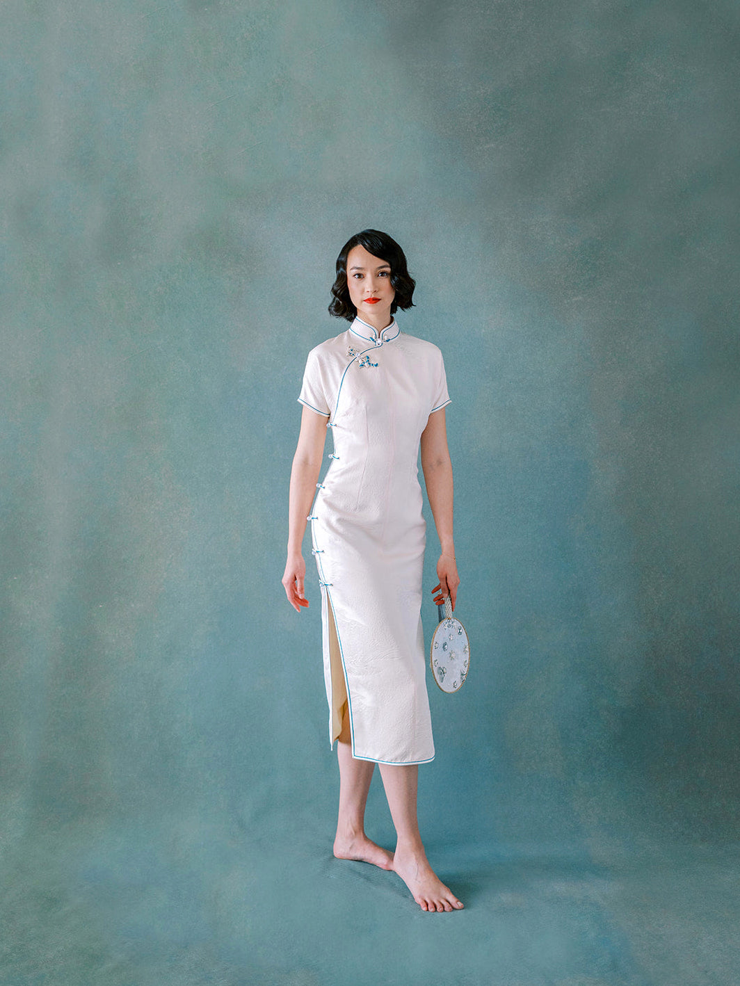 White silk Qipao with blue trim and side Pankou button closure