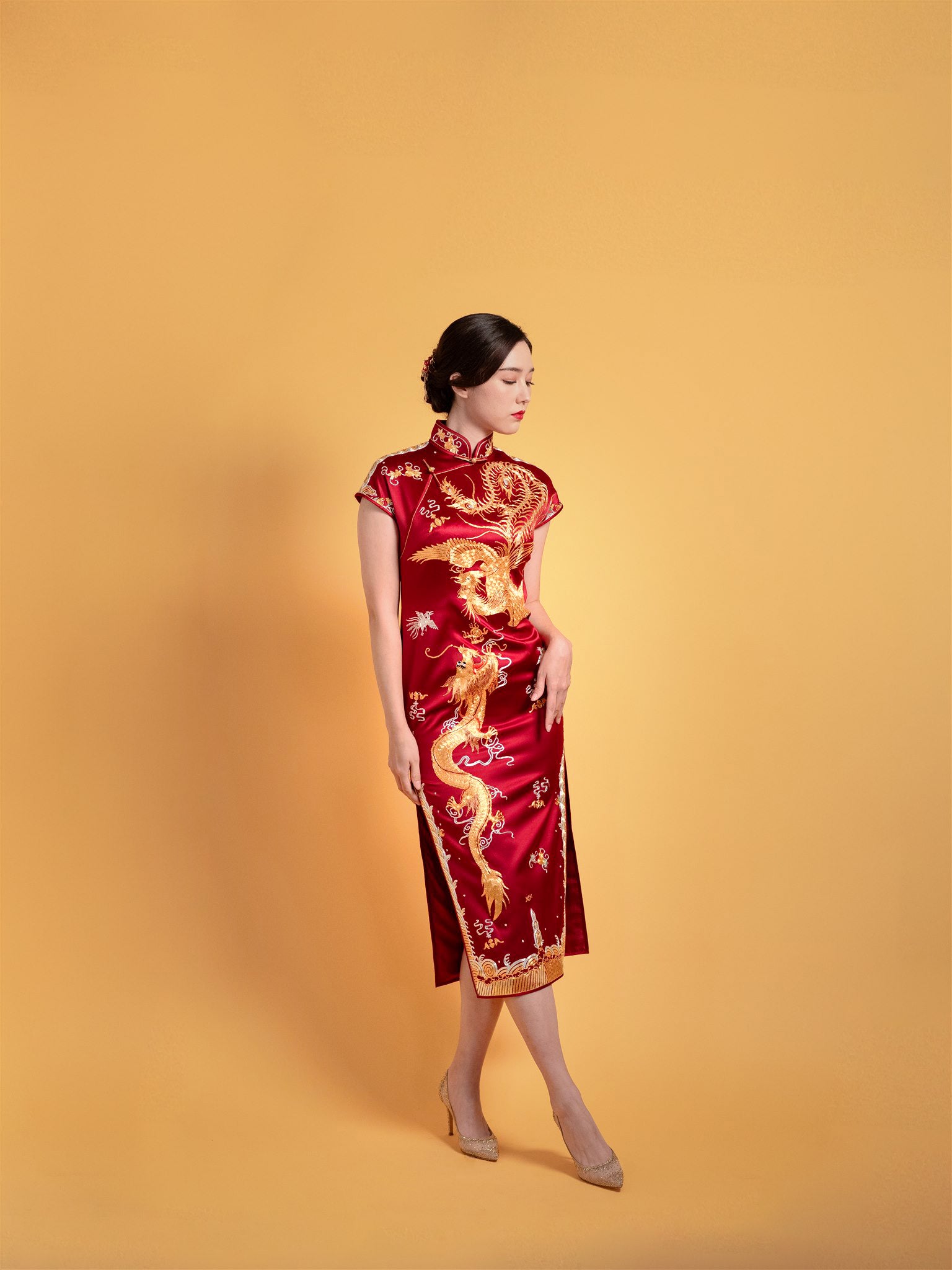 Side view of Wine Red Goldwork I Chinese wedding dress showing mid-calf cut and gold embroidery.