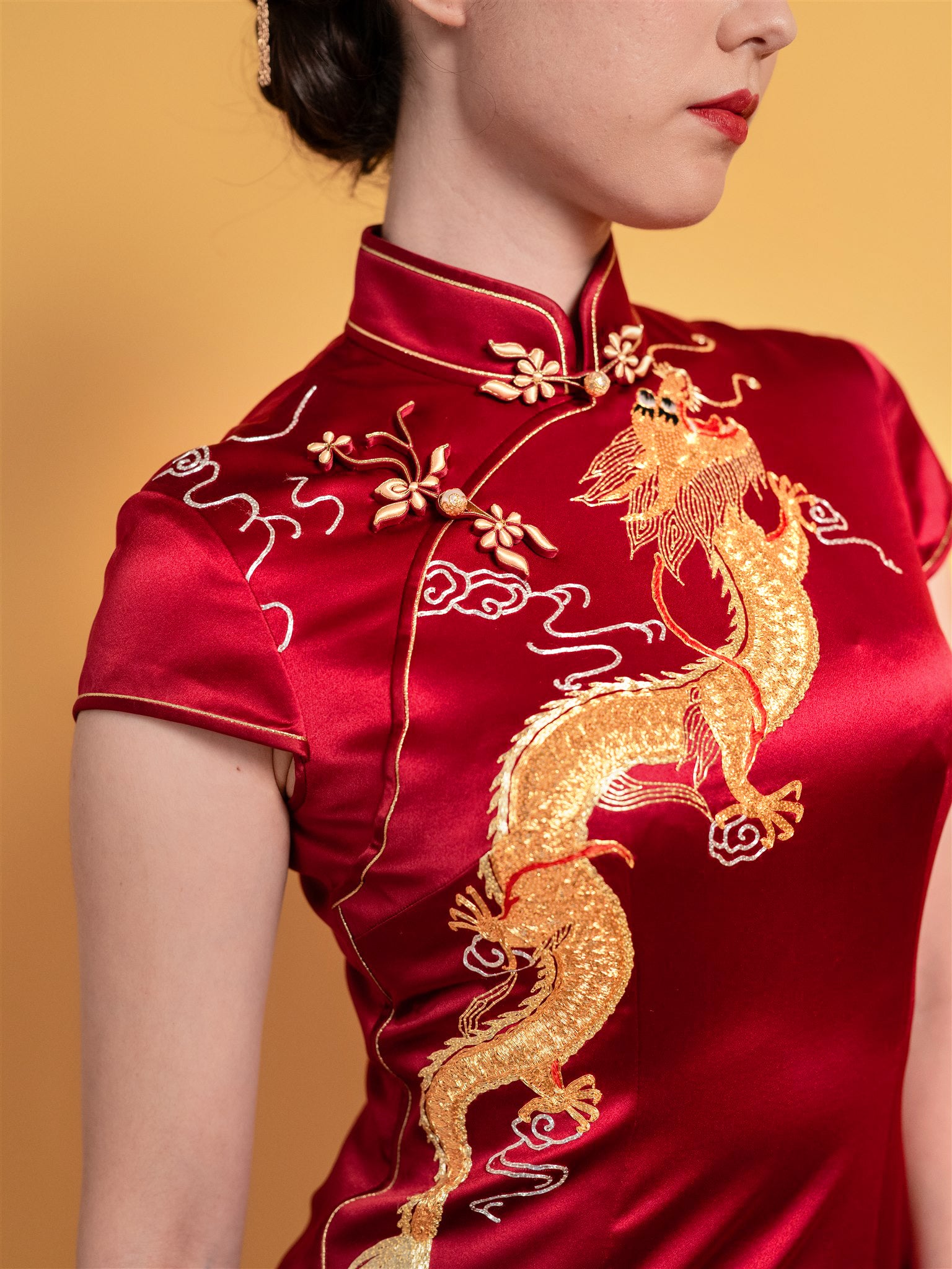 Dragon embroidery detail on bodice of wine red mermaid Qipao Chinese wedding dress.