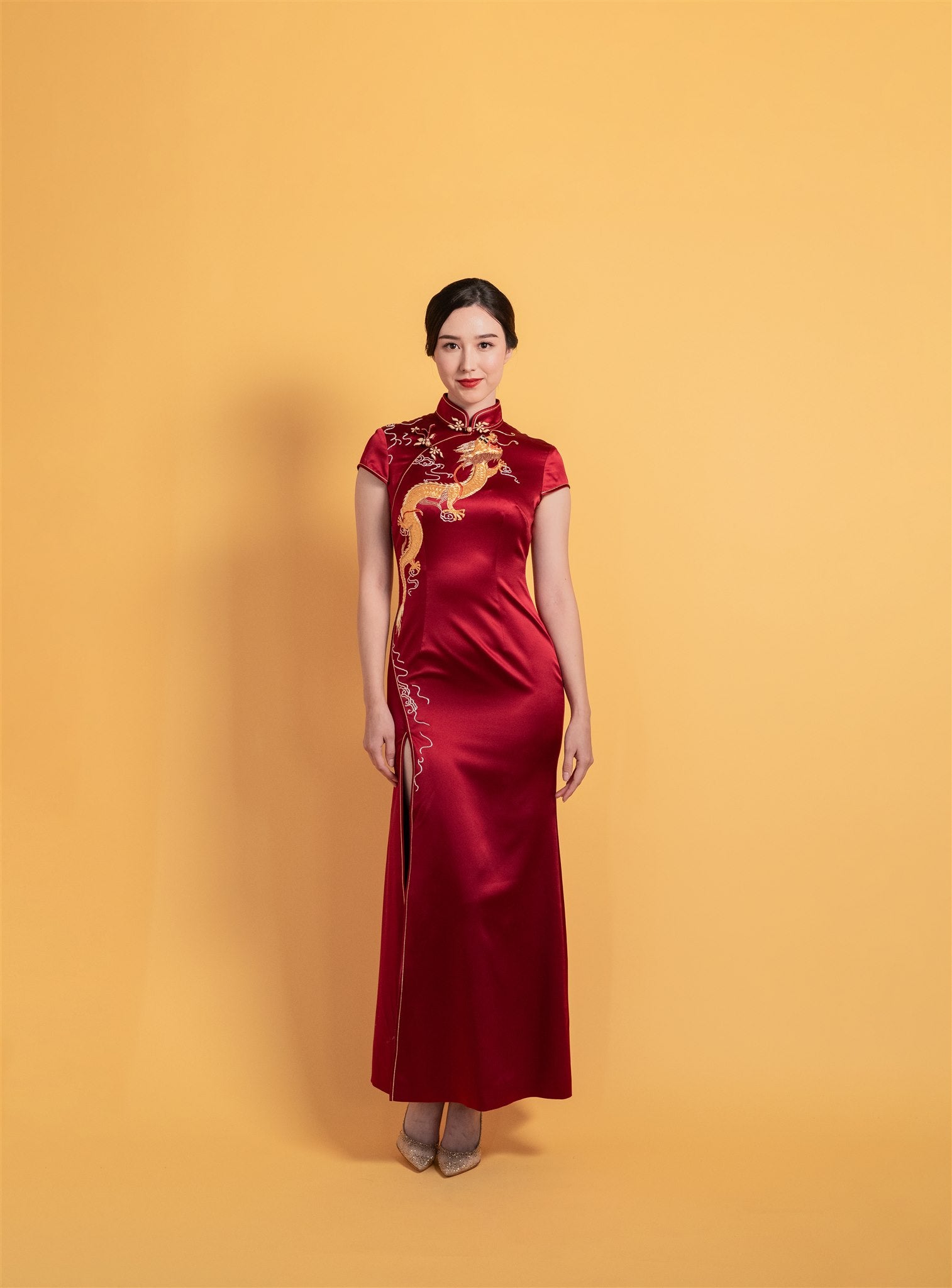Front view of wine red mermaid Qipao Chinese wedding dress with dragon embroidery.