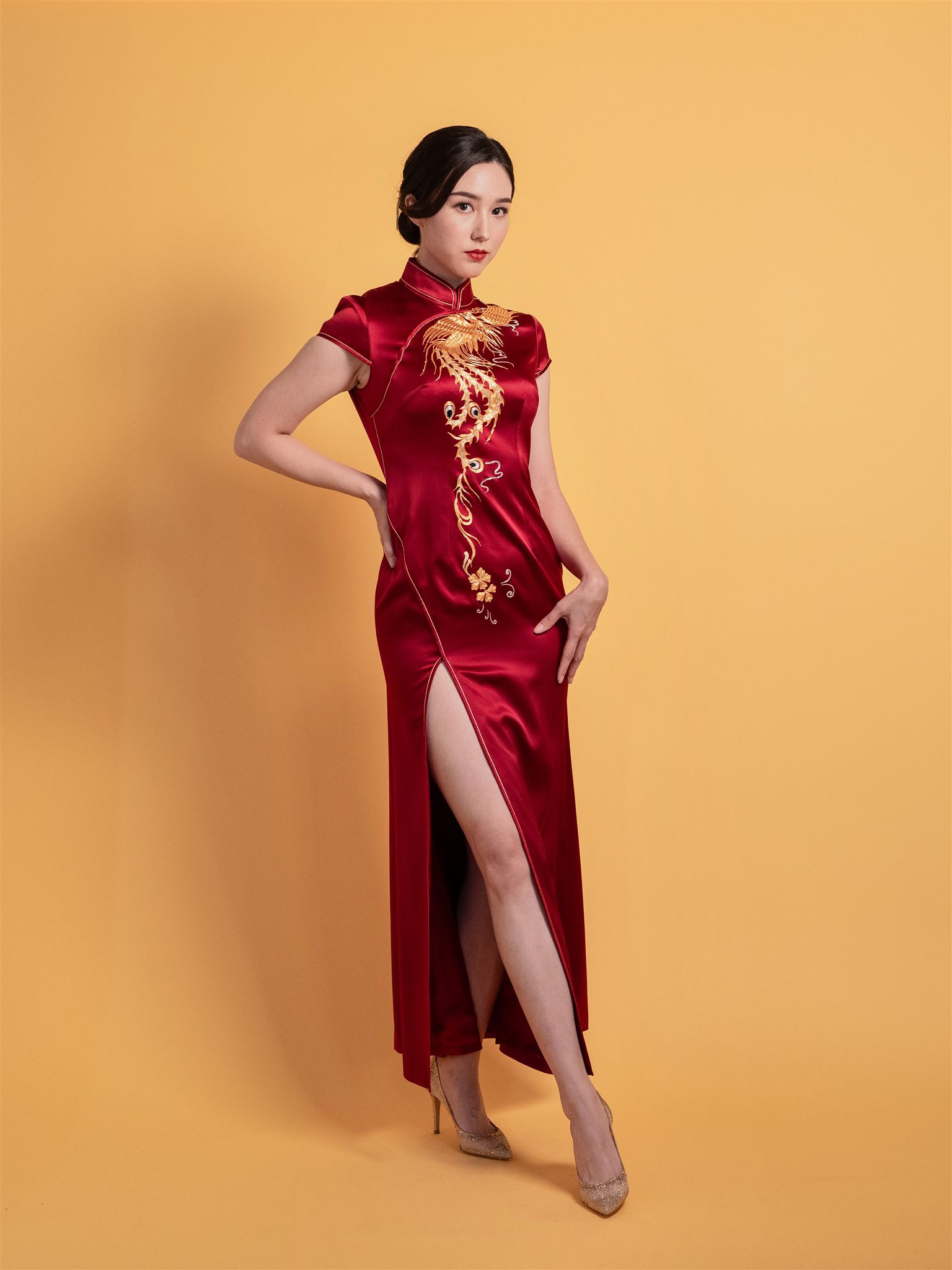 Side view of wine red mermaid Qipao Chinese wedding dress with fitted silhouette and optional train.
