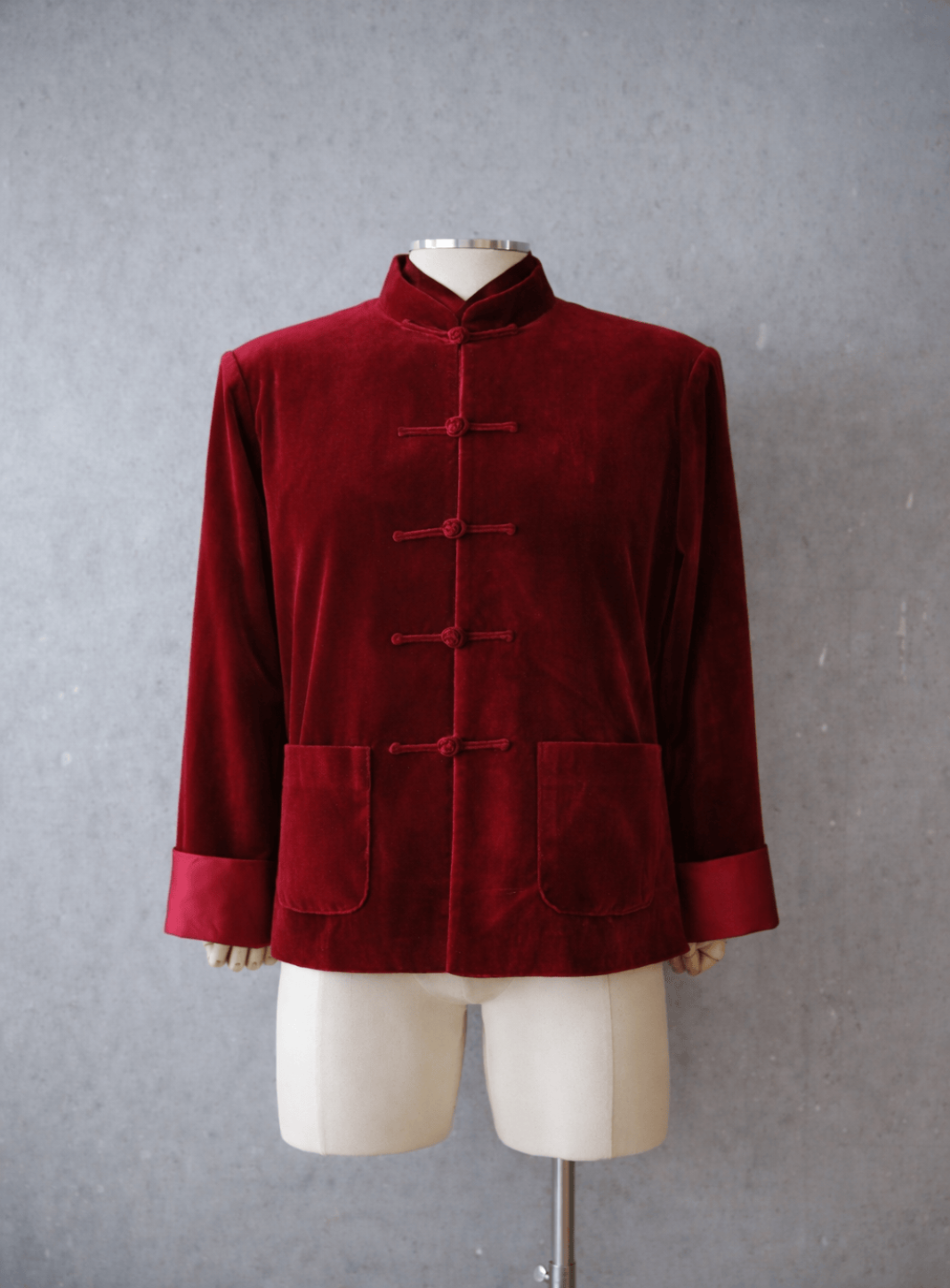 Wine red silk velvet Tang suit jacket with traditional pankou closures, front view.