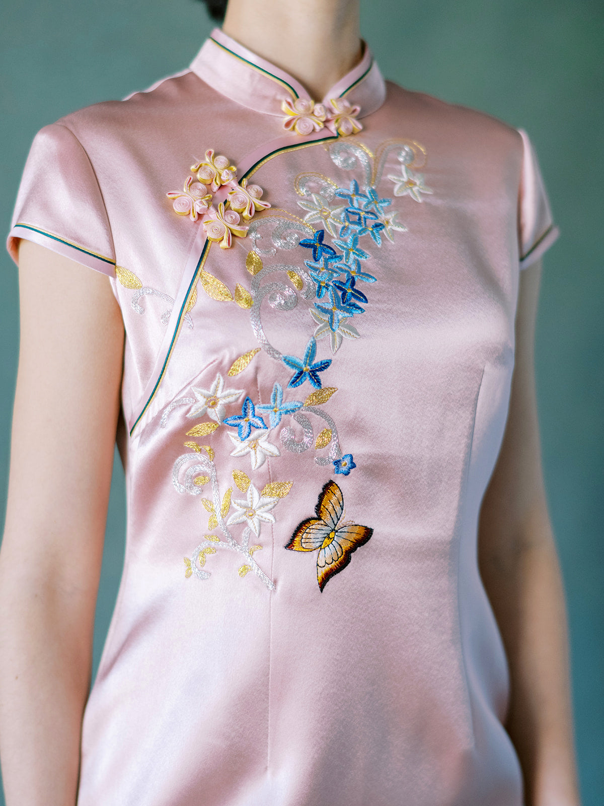 Hand embroidery of butterfly and flower motifs on blush pink silk Qipao