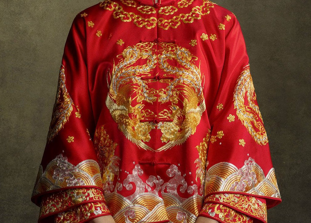 A bride wearing a Chinese Traditional Tea Ceremony dress - Xiu He Fu