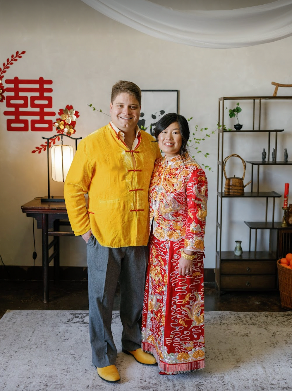 A man wearing silk gold velvet tang suit for his Chinese tea ceremony