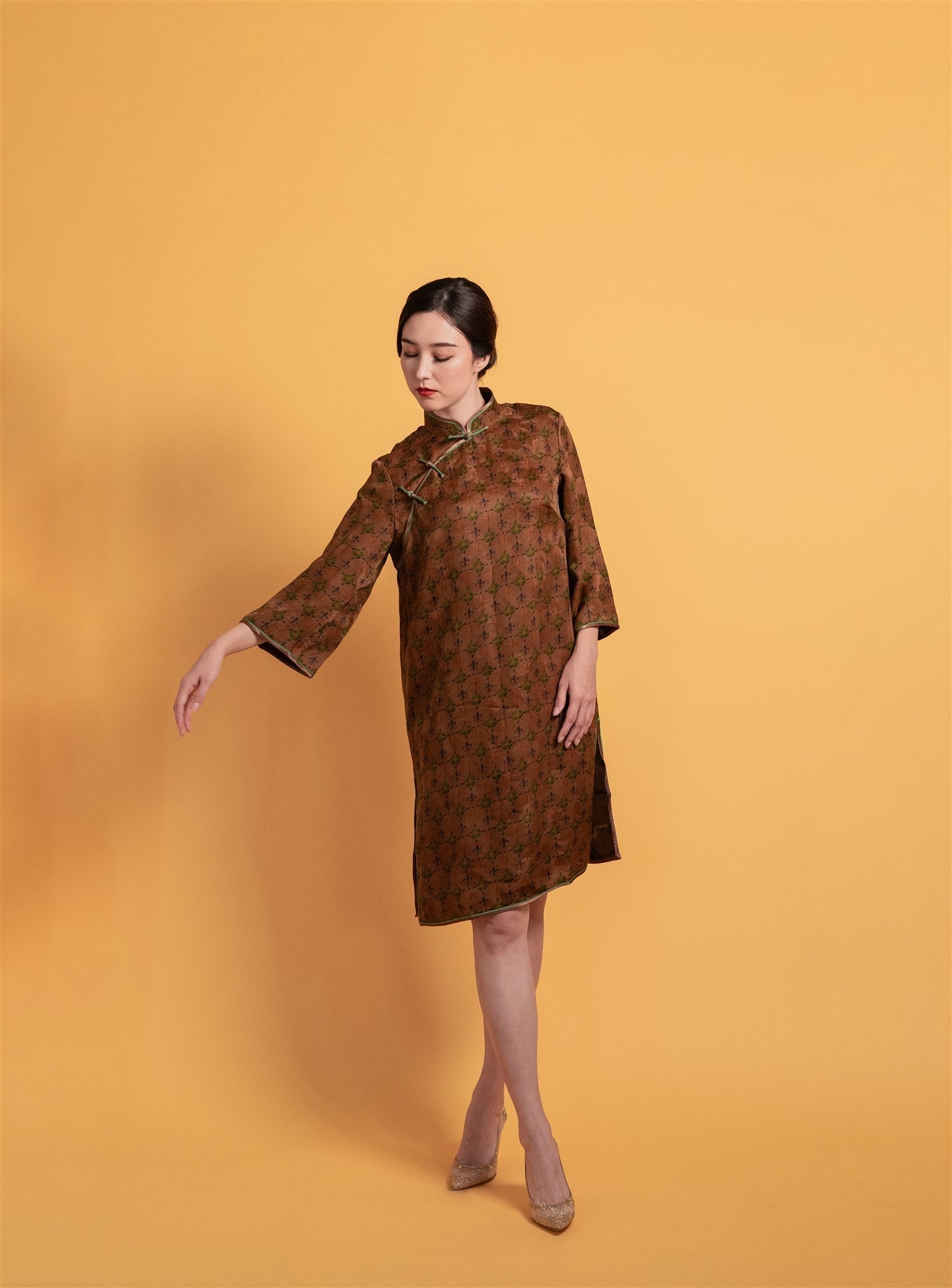 Brown Xiang Yun silk Qipao dress with an A-line silhouette, 3/4 sleeves, and over-the-knee length, a traditional Chinese dress with a flattering sihouette.