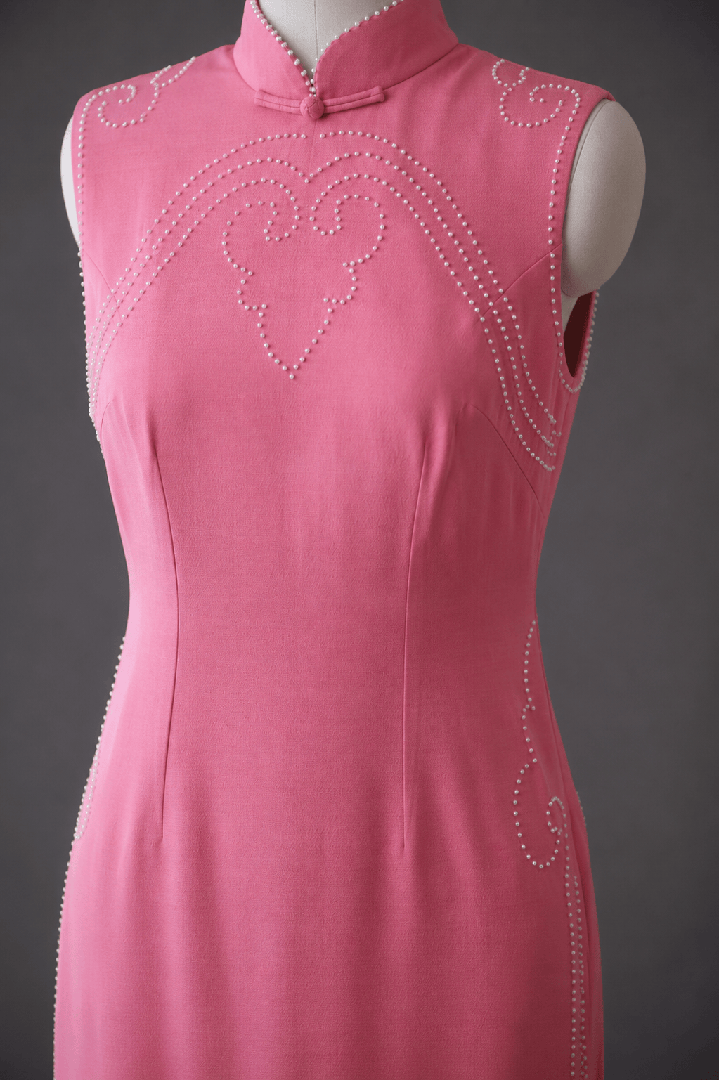 Mid body detail of hand sewn pearl heart and cloud scroll motif on baby pink silk crepe fitted Qipao — JINZA Oriental Couture, Los Angeles