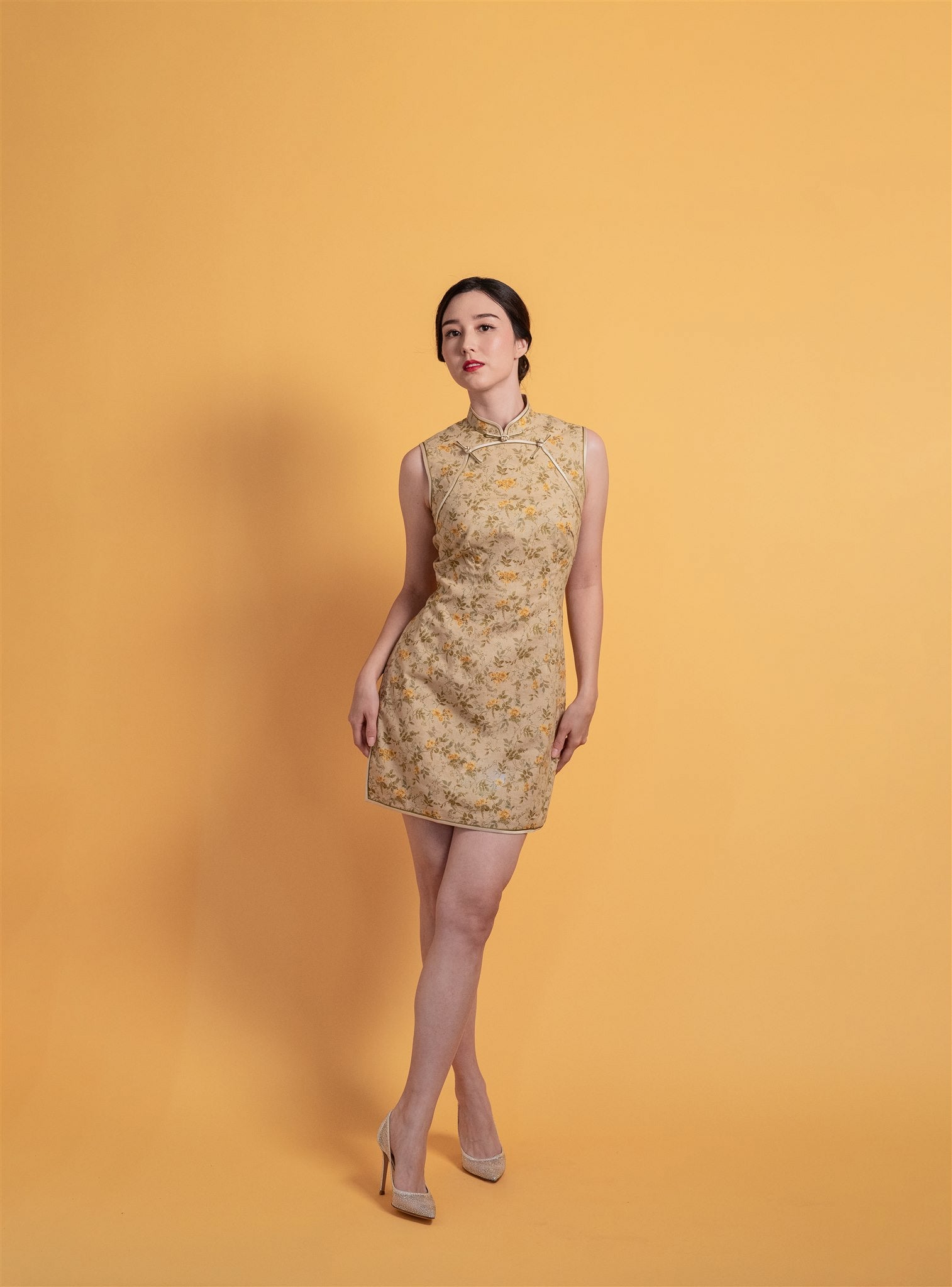 Front view of a beige cotton sleeveless modern Cheongsam dress with a mandarin neckline, front buttons, and over-the-knee length, perfect for parties and daily comfort.