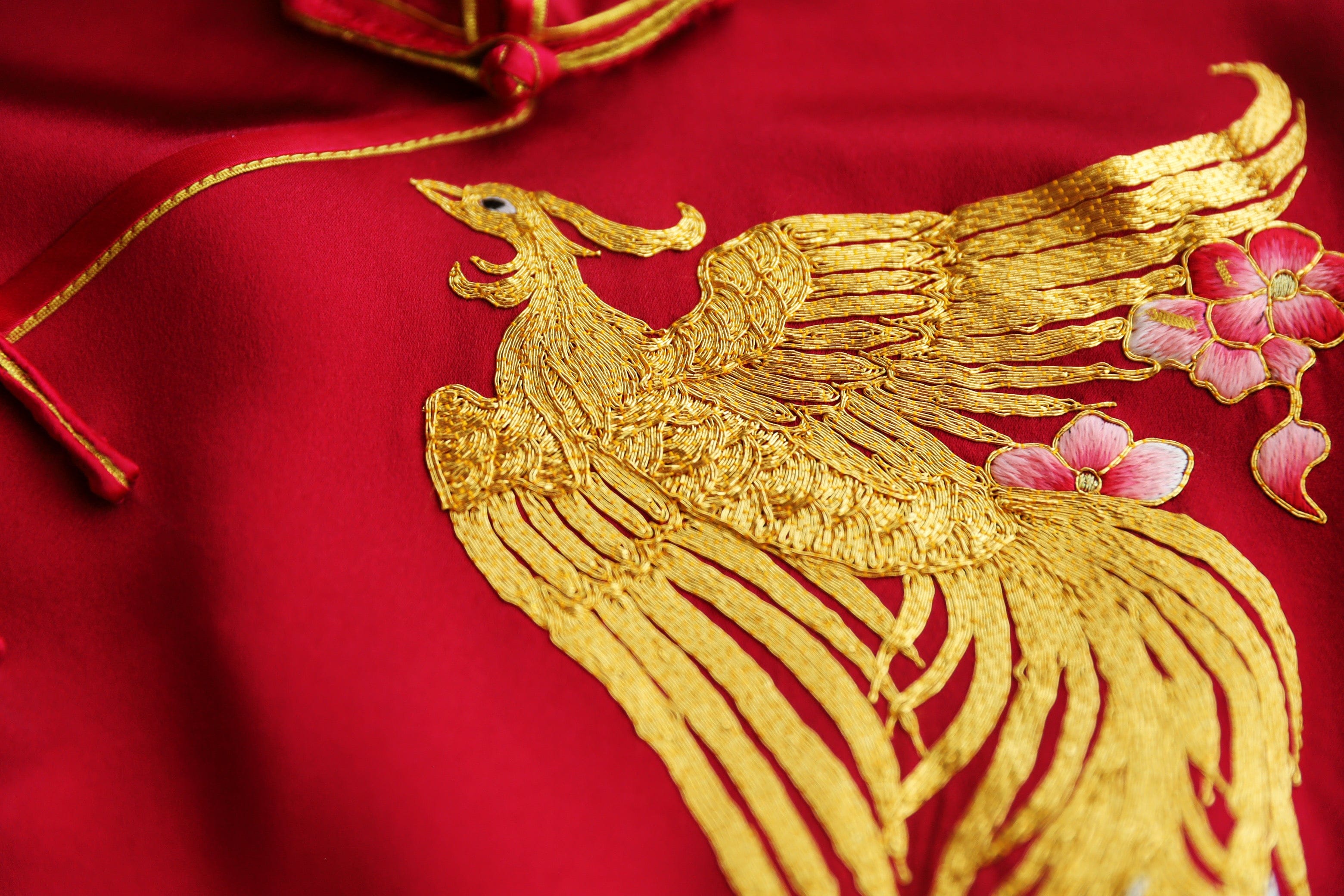Hand embroidered phoenix and peony detail on red silk bespoke wedding Qipao, custom made to measure Chinese wedding dress at JINZA Los Angeles