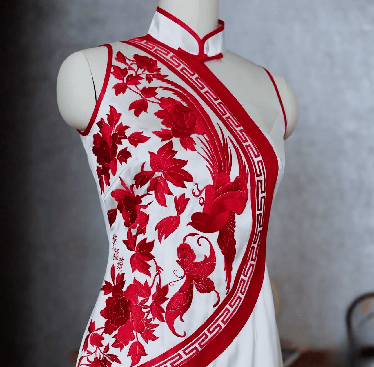 Bespoke white silk Qipao with red hand embroidered bird, peony and butterfly motifs and halter neckline, custom made to measure at JINZA Los Angeles