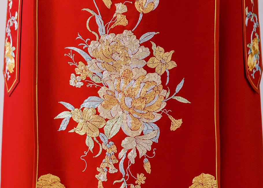 Hand embroidered peony detail on red bespoke Xiu He Fu Chinese wedding dress, custom made to measure at JINZA Los Angeles